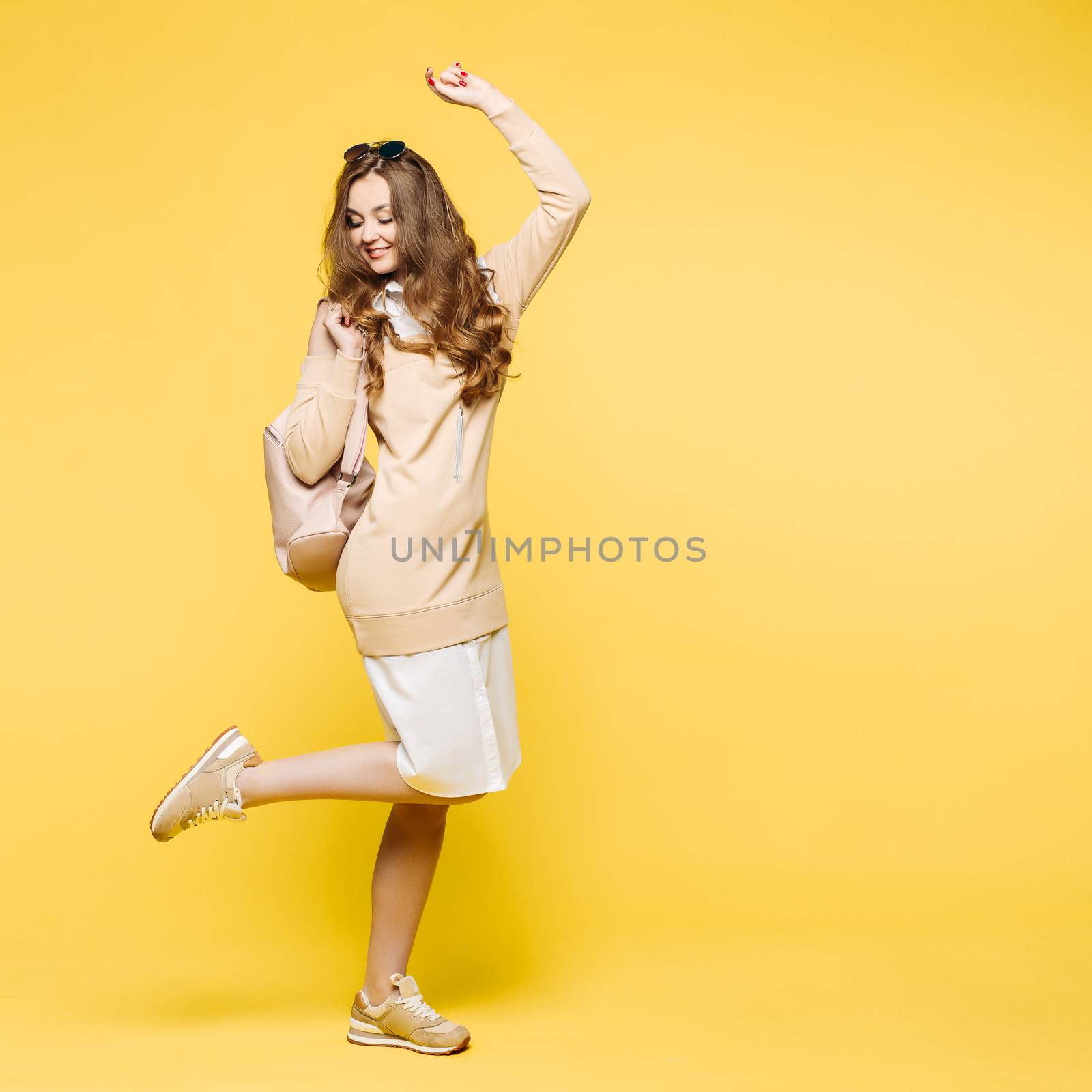 Beautiful fashionable brunette in sunglasses, posing at studio. by StudioLucky