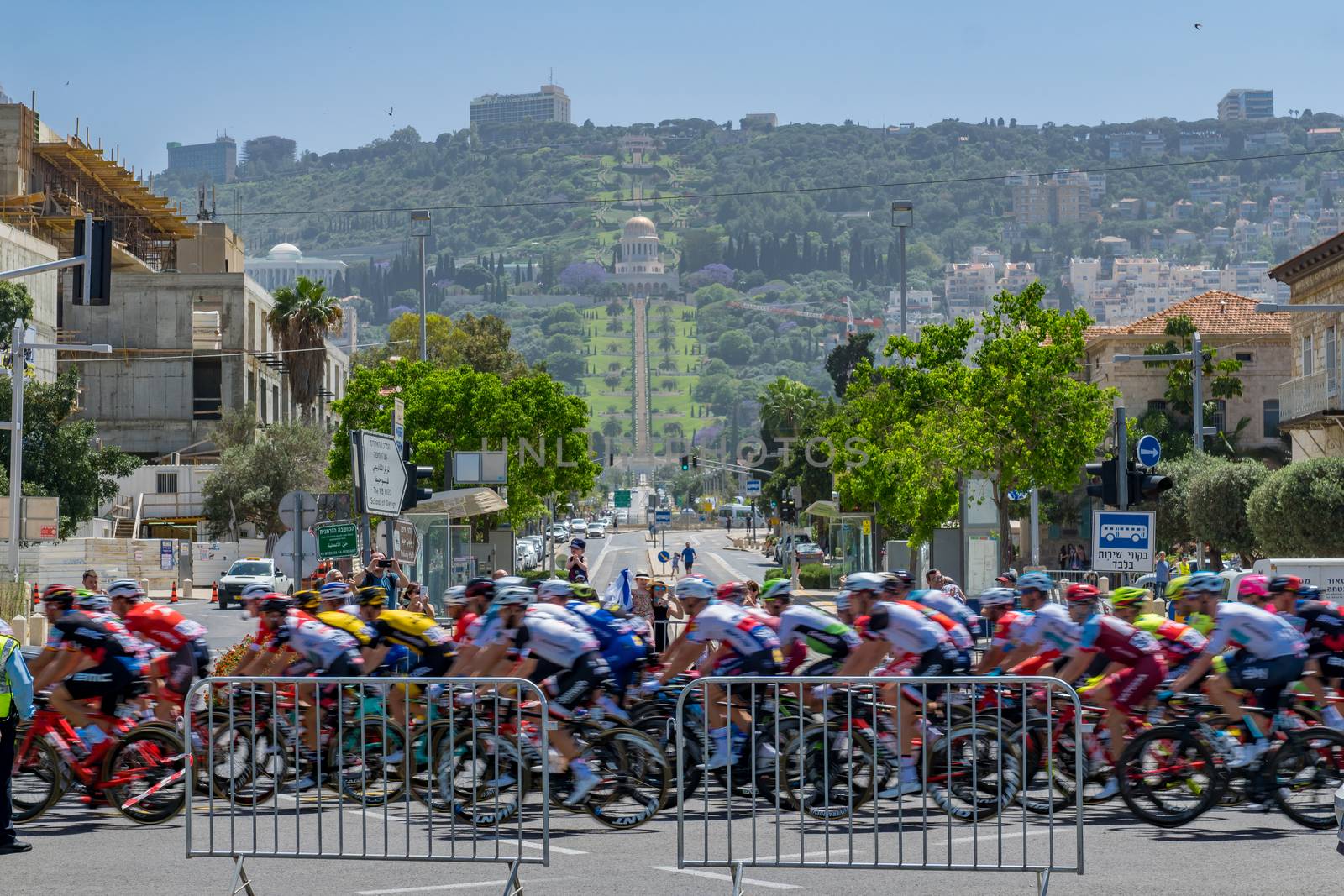 HAIFA, ISRAEL - MAY 05, 2018: Scene of stage 2 of 2018 Giro d Italia, with cyclists and spectators, and the German Colony, Bahai gardens and shrine in the background. Haifa, Israel
