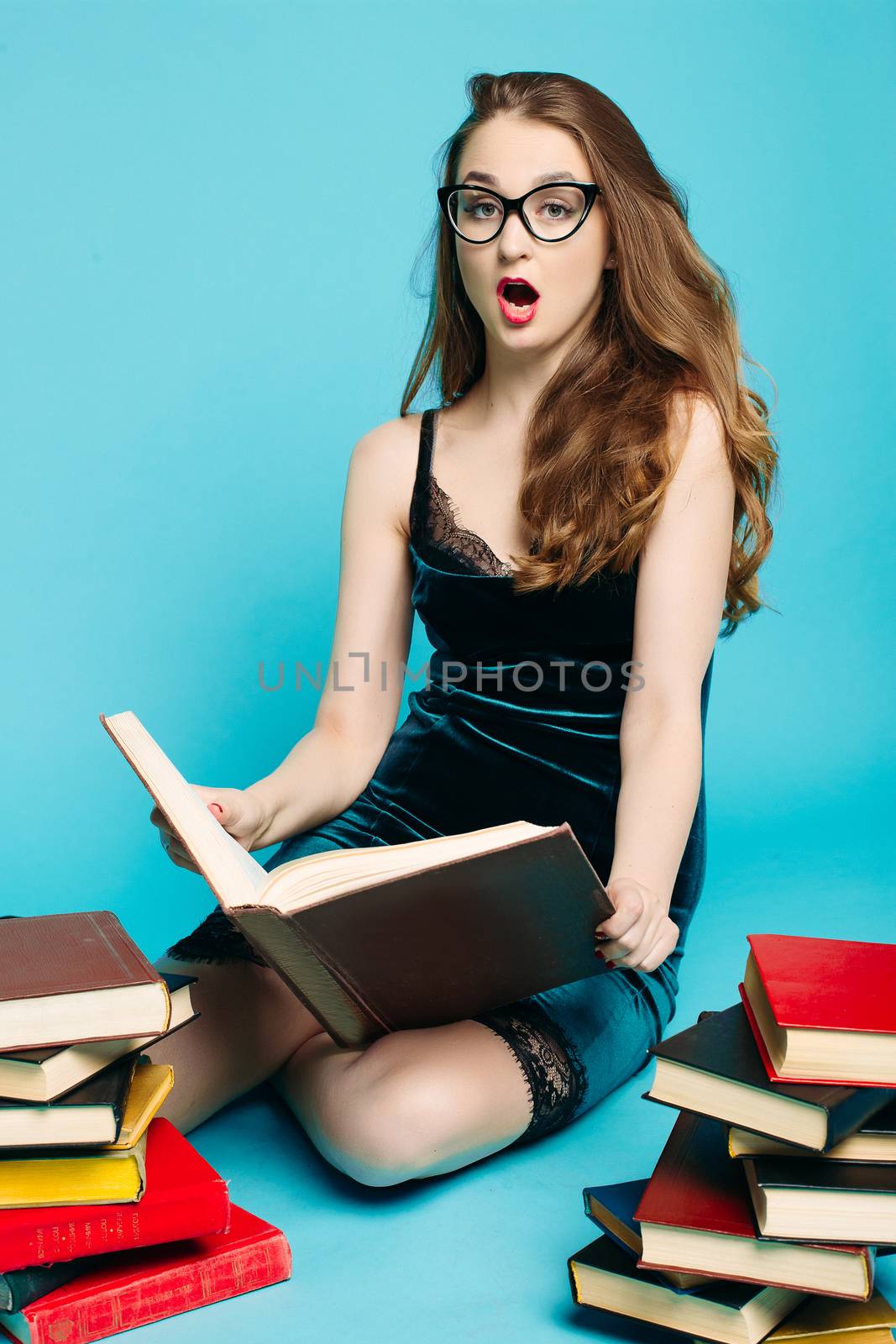 Sexy teacher among books holding heels and making duck face. by StudioLucky