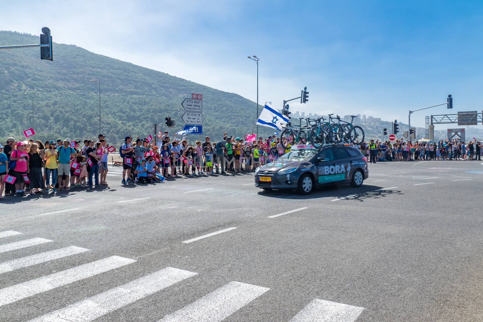 YAGUR, ISRAEL - MAY 05, 2018: Scene of stage 2 of 2018 Giro d Italia, with team car and spectators, in Yagur, Israel