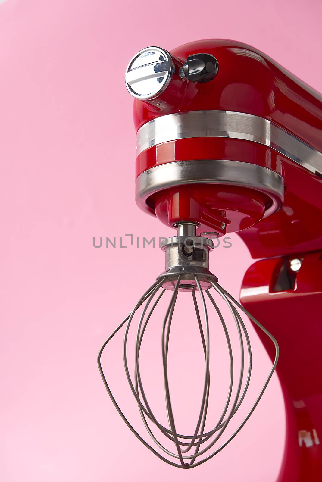 Stylish Red Kitchen Mixer With Clipping Path Isolated On pink Background. Professional steel electric mixer with Metal Whisk.