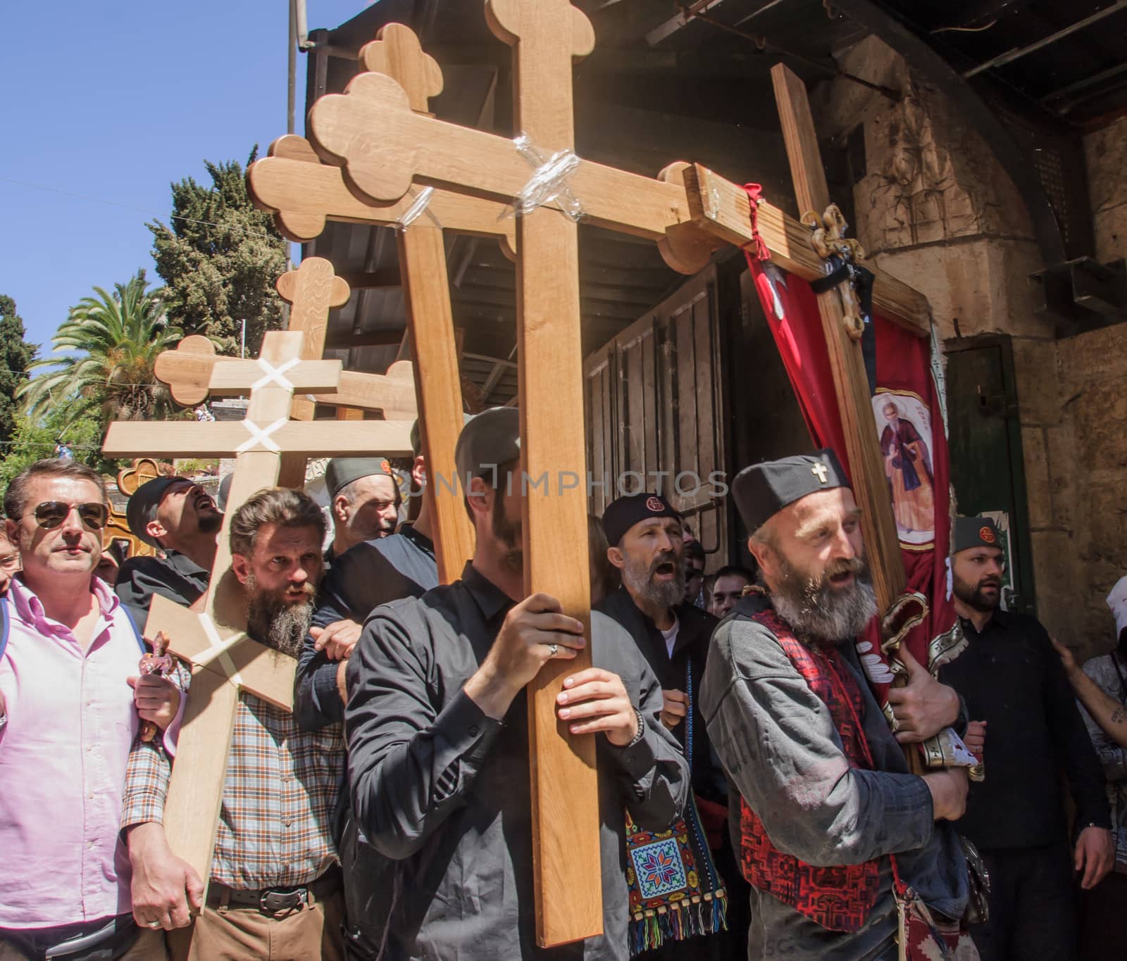 JERUSALEM - APRIL 18, 2014: Pilgrims from all over the world commemorating the crucifixion of Jesus Christ by carrying a cross along via dolorosa, on good Friday, in the old city of Jerusalem, Israel