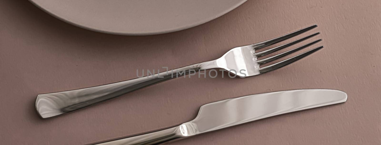 Empty plate and cutlery as mockup set on brown background, top tableware for chef table decor and menu branding design
