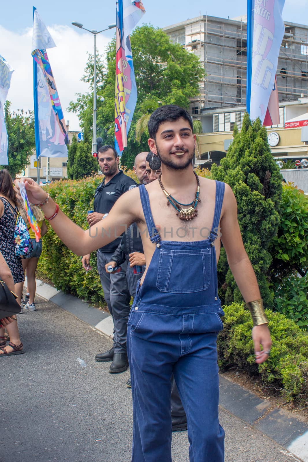 HAIFA, ISRAEL - JUNE 22, 2018: Portrait of a participant, and others in the background, in the annual pride parade of the LGBT community, in Haifa, Israel