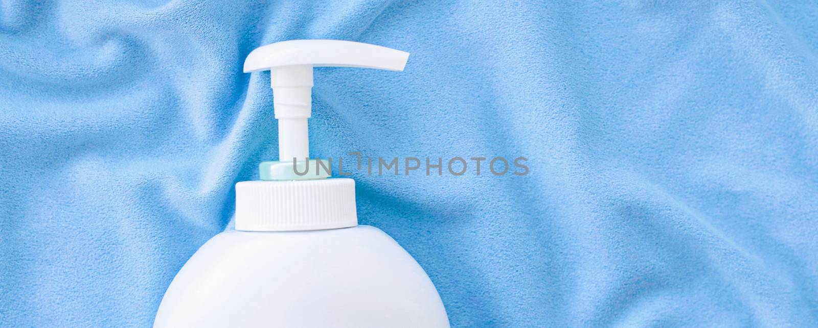 Blank label bottle of antibacterial liquid soap and hand sanitizer mockup on blue silk, hygiene product and health care, flatlay