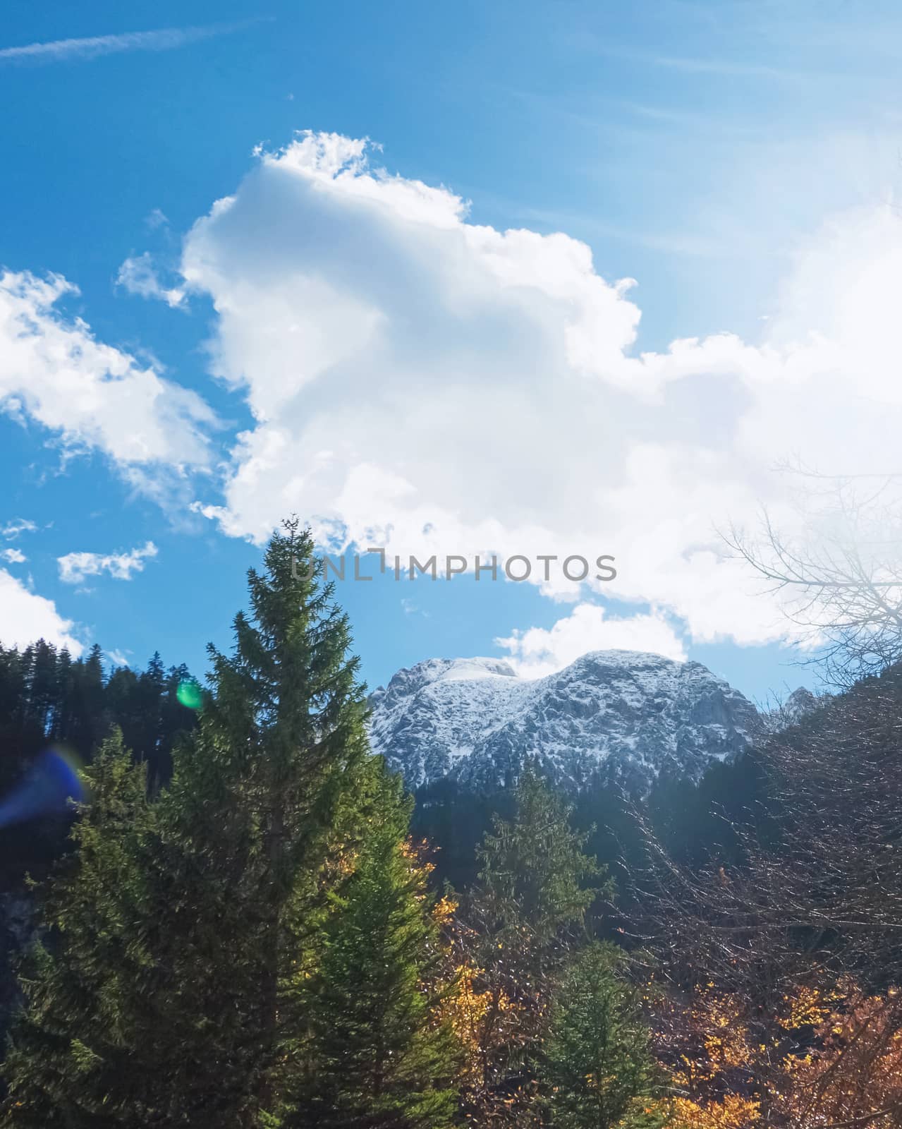 Beautiful nature of European Alps, landscape view of alpine mountains, lake and village on a sunny day, travel and destination scenery