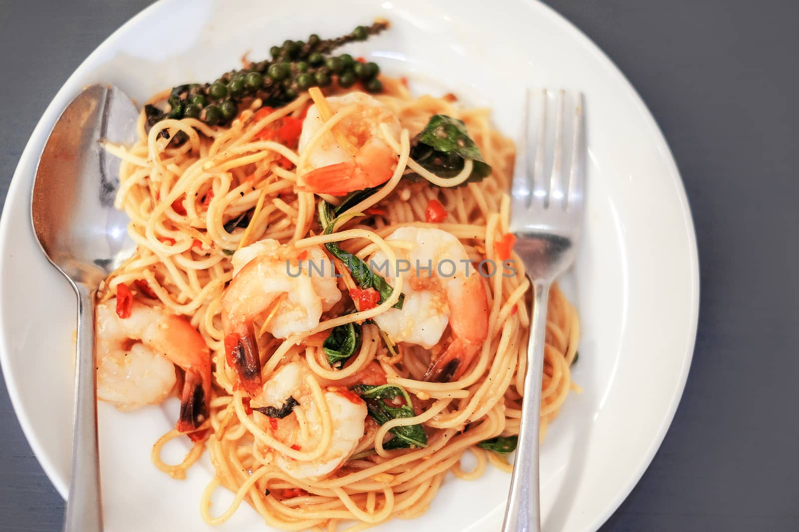 Spaghetti with seafood on gray background