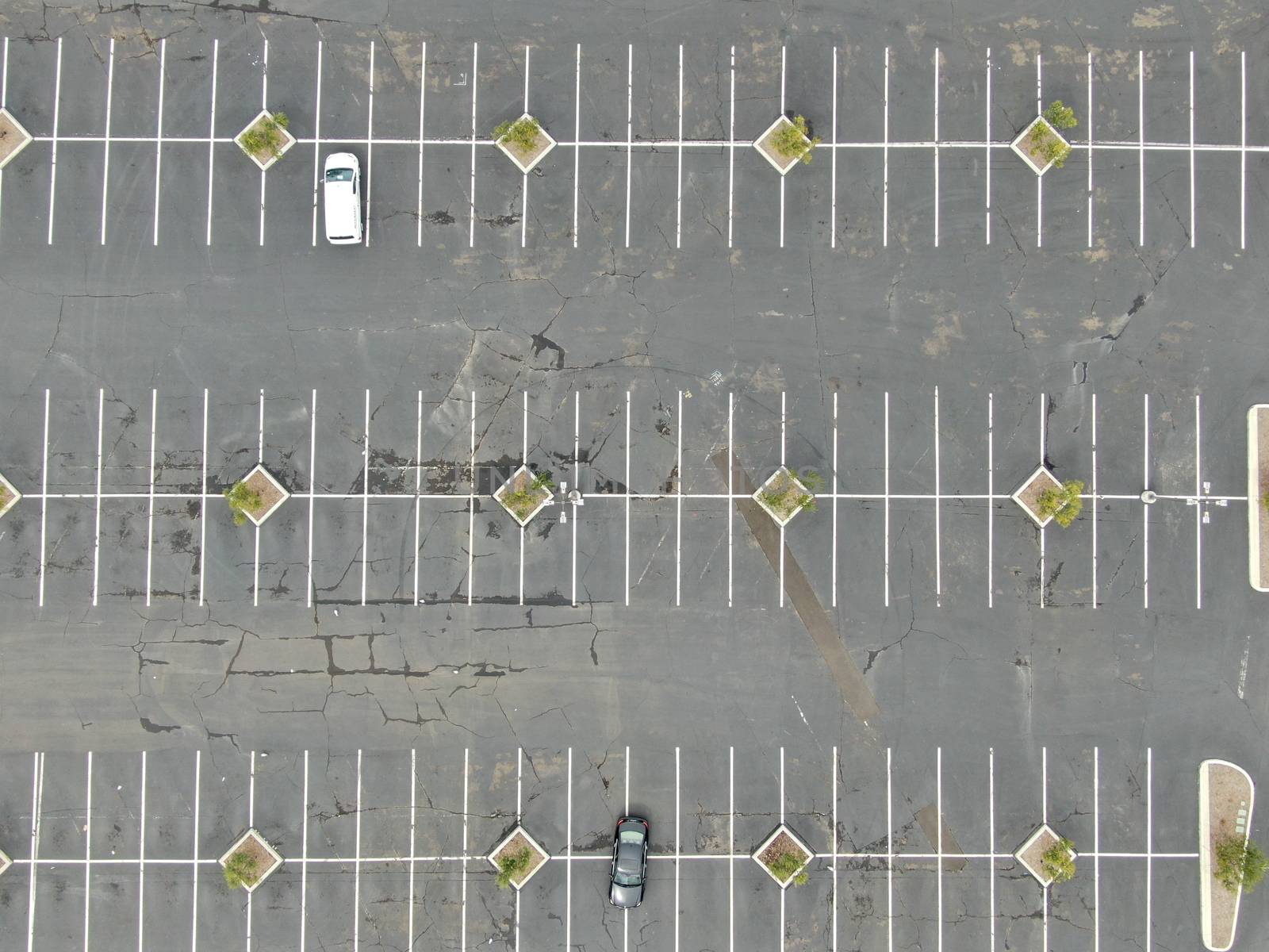 Aerial view of empty shopping center parking lot during COVID-19 pandemic.. Coronavirus virus and panic buying concept