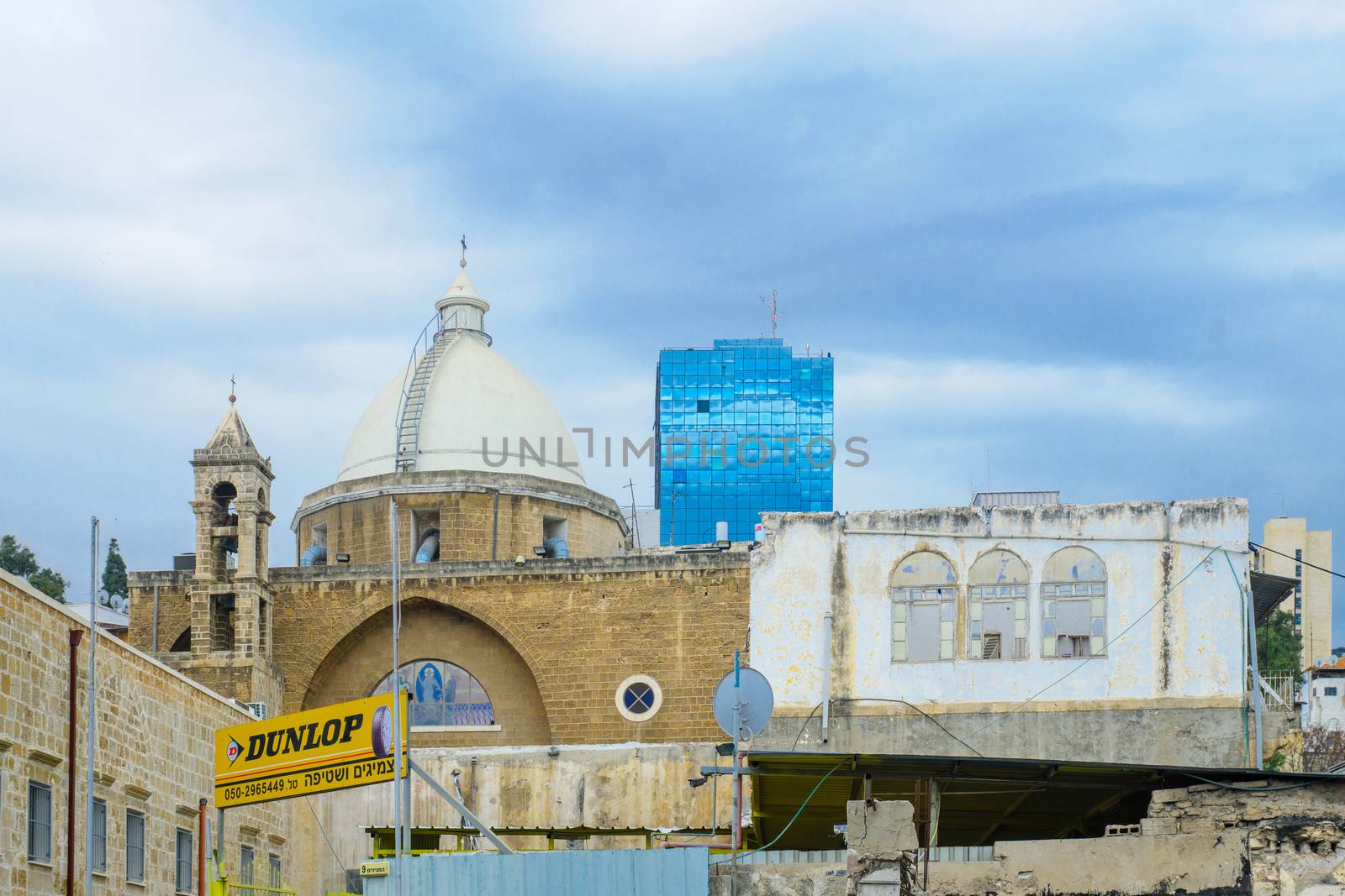 HAIFA, ISRAEL - DECEMBER 08, 2016: View of the Maronite Cathedral of St. Louis the King, with HaNeviim tower in the background, in Haifa, Israel