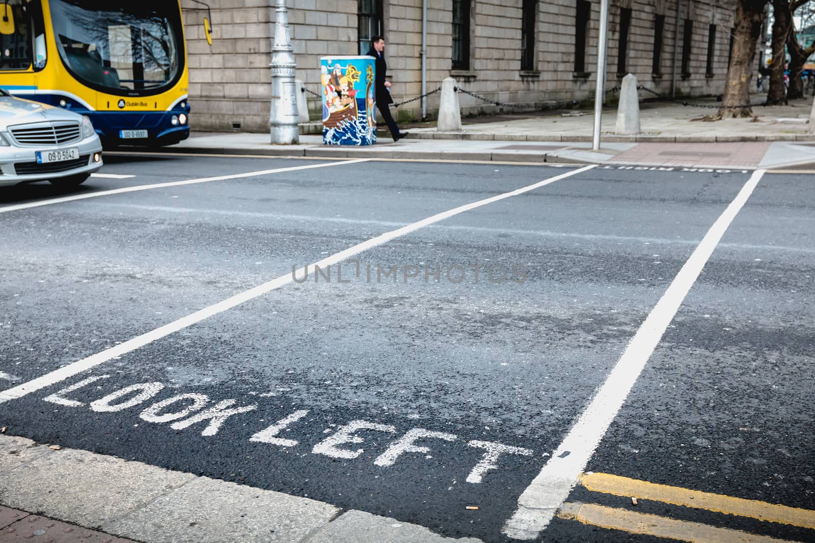 Dublin, Ireland - February 11, 2019: Look Left painted in white on the road on a pedestrian crossing in the city center on a winter day