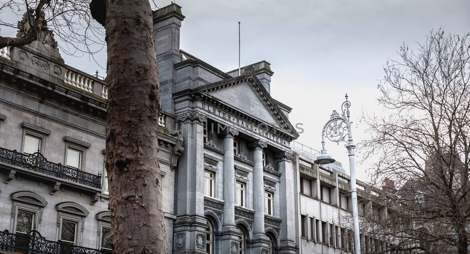 Dublin, Ireland - February 11, 2019: Architectural detail and street atmosphere in front of the Ulster Bank Commercial Bank building in the historic city center on a winter day