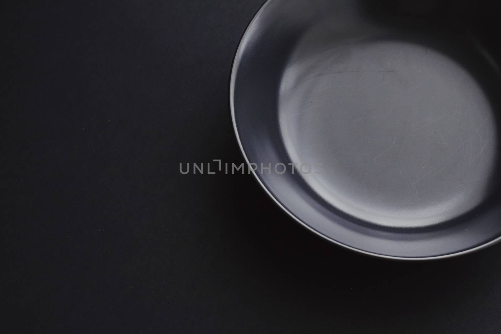 Empty plates on black background, premium dishware for holiday dinner, minimalistic design and diet concept