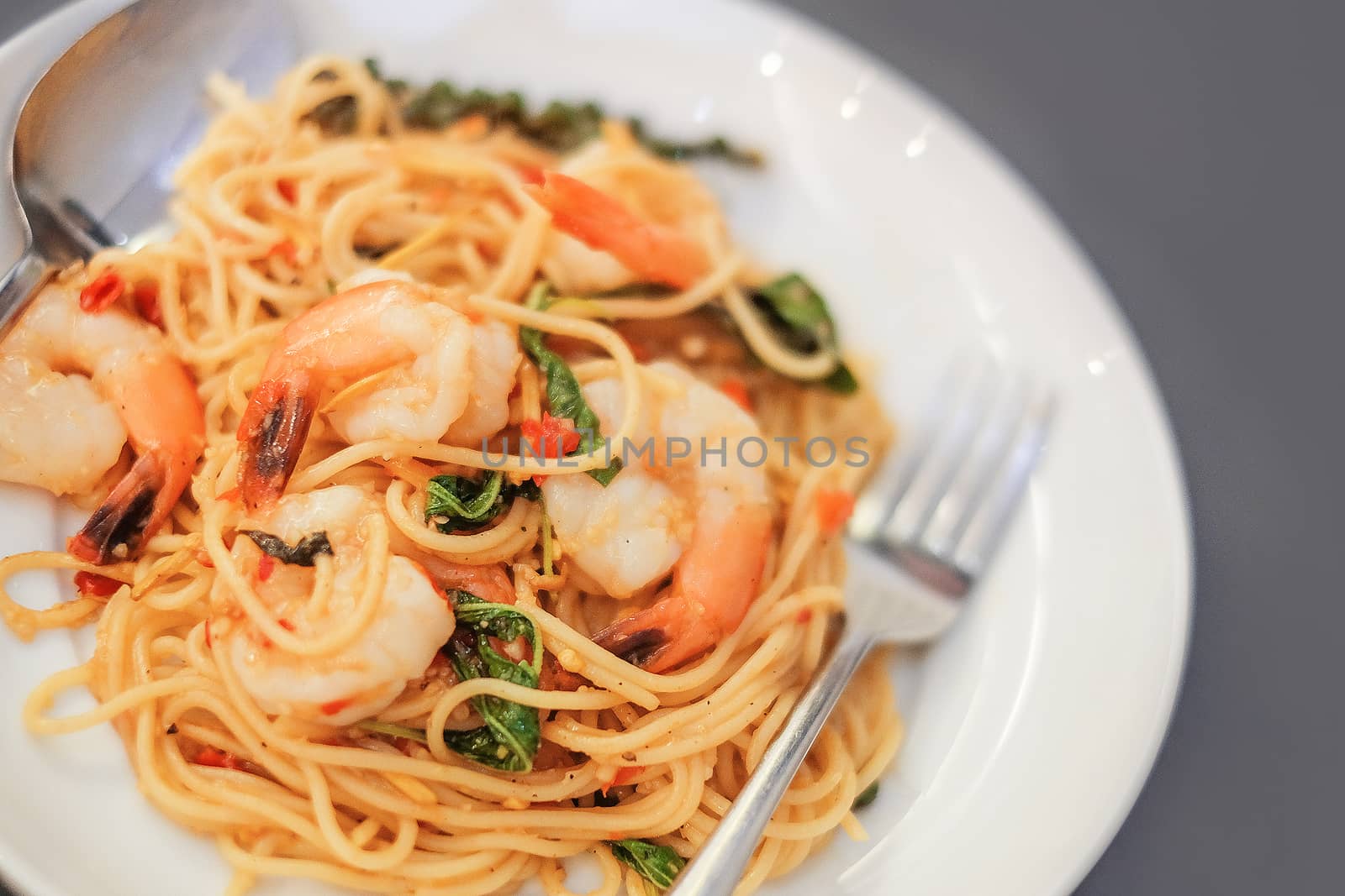 Spaghetti with seafood on gray background by Surasak
