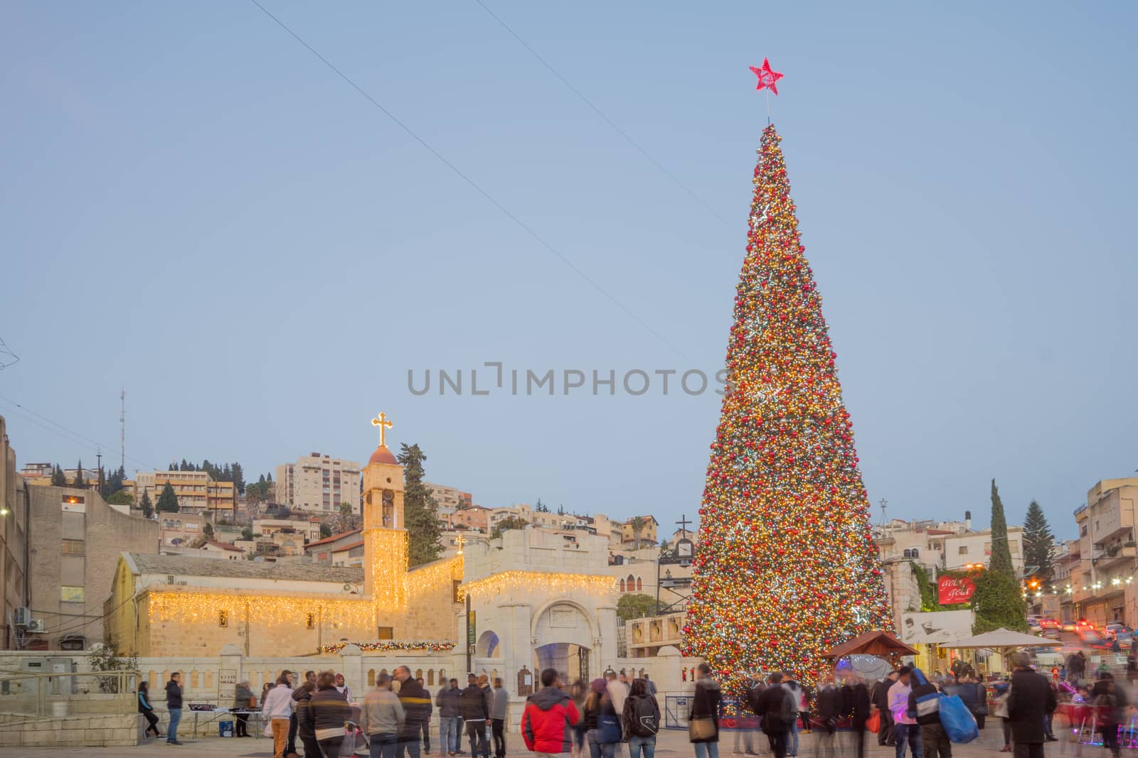 NAZARETH, ISRAEL - DECEMBER 20, 2016: Christmas scene of Mary Well square, with the Greek Orthodox Church of the Annunciation, a Christmas tree, locals and tourists, in Nazareth, Israel