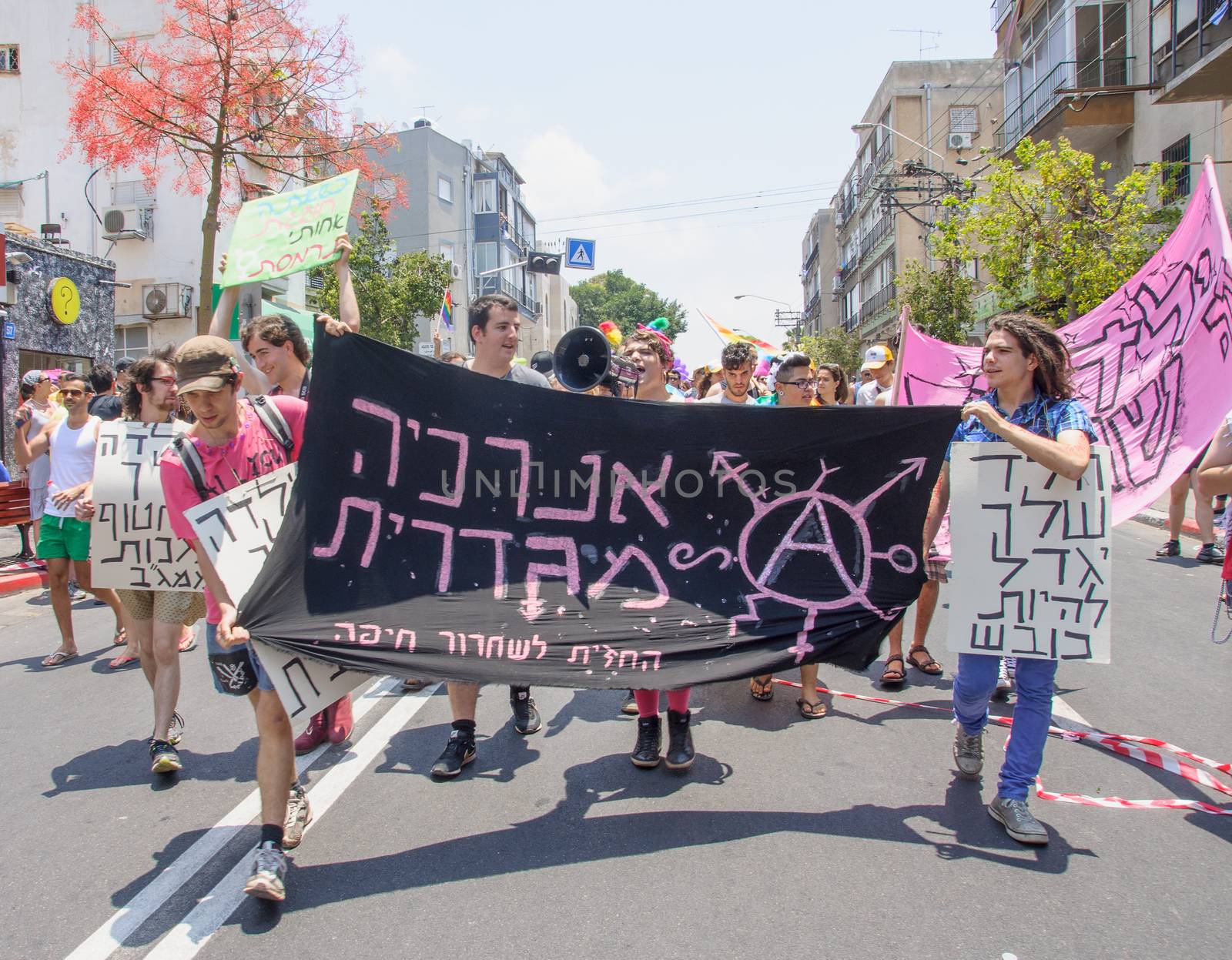 TEL-AVIV - JUNE 13, 2014: A group of anarchists march in the Pride Parade in the streets of Tel-Aviv, Israel. The pride parade is an annual event of the gay community