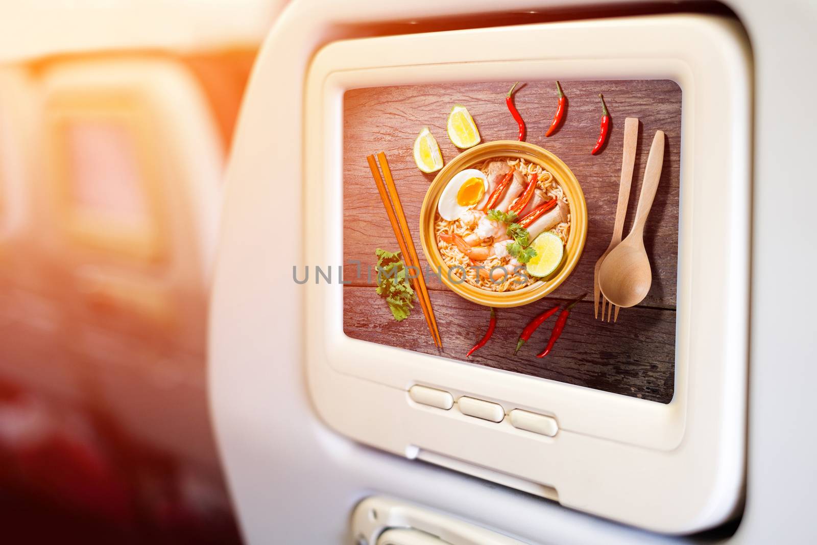 Aircraft monitor in front of passenger seat showing Thai food style noodle, Ma Ma tom yum kung 