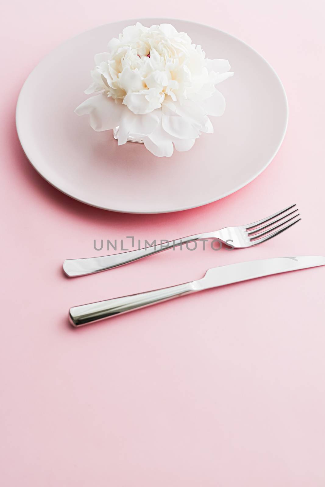 Dining plate and cutlery with peony flower as wedding decor set on pink background, top tableware for event decoration and dessert menu by Anneleven