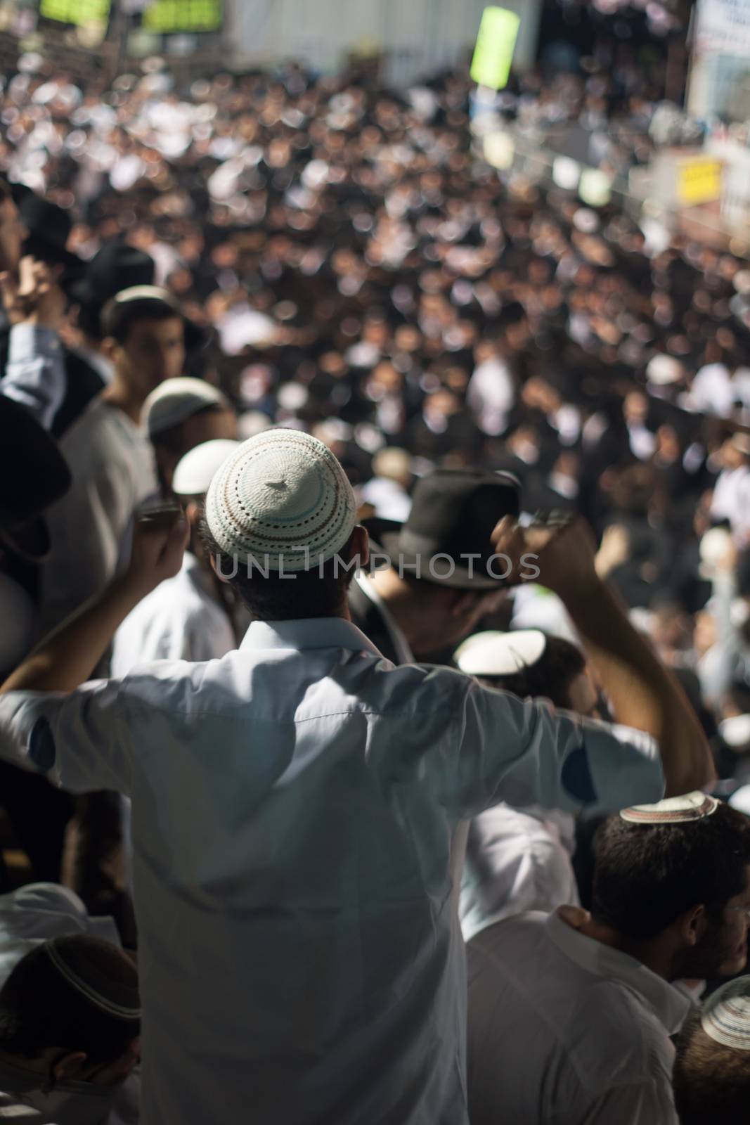 MERON, ISRAEL - MAY 18, 2014: An orthodox Jew raise his hands in dance at the annual hillulah (celebration) of Rabbi Shimon Bar Yochai, in Meron, on Lag BaOmer Holiday.