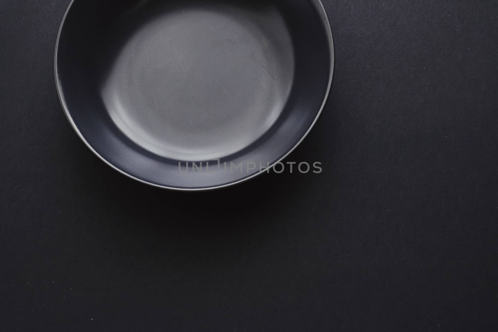 Empty plates on black background, premium dishware for holiday dinner, minimalistic design and diet concept