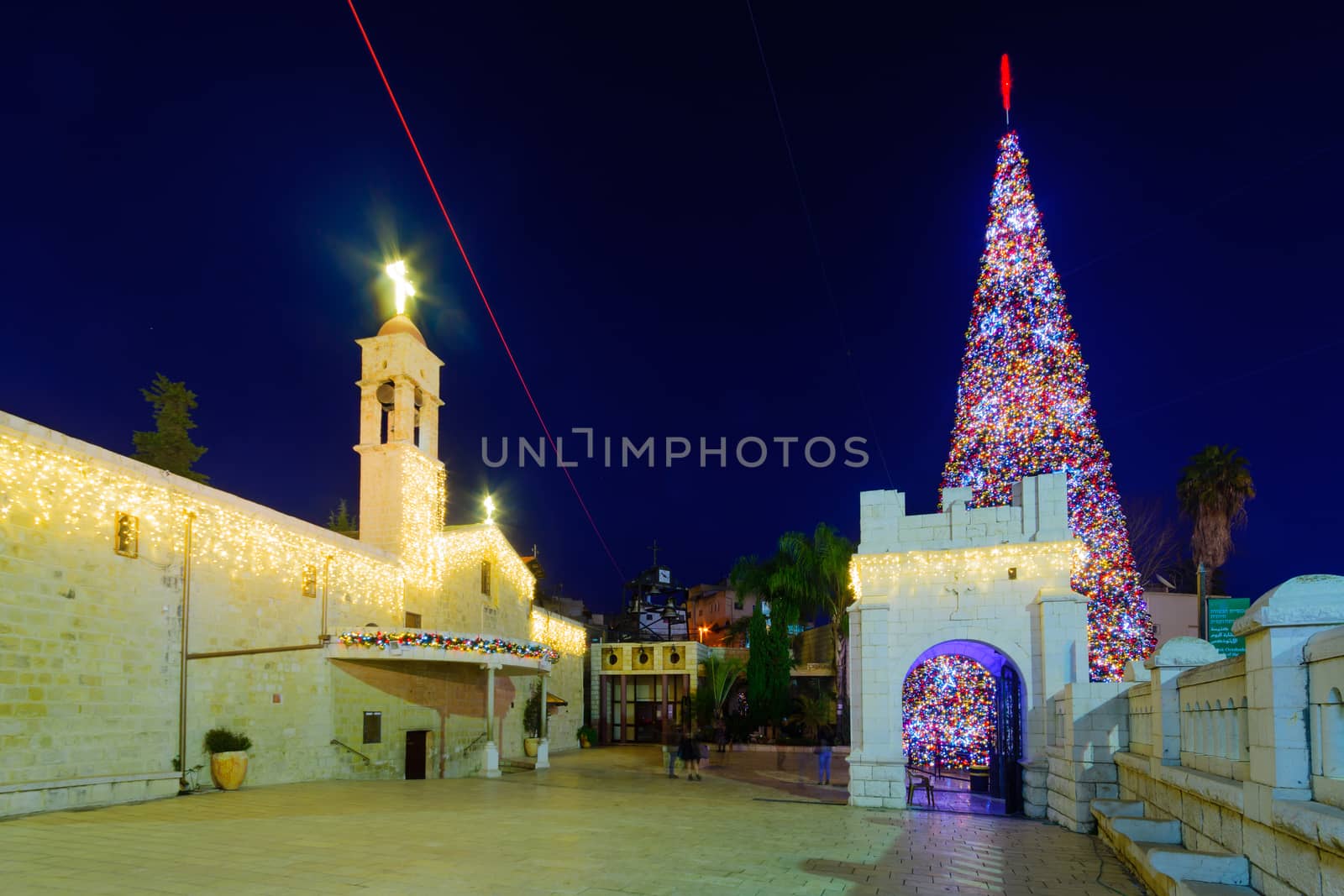 NAZARETH, ISRAEL - DECEMBER 20, 2016: Christmas scene of Mary Well square, with the Greek Orthodox Church of the Annunciation, a Christmas tree, locals and tourists, in Nazareth, Israel