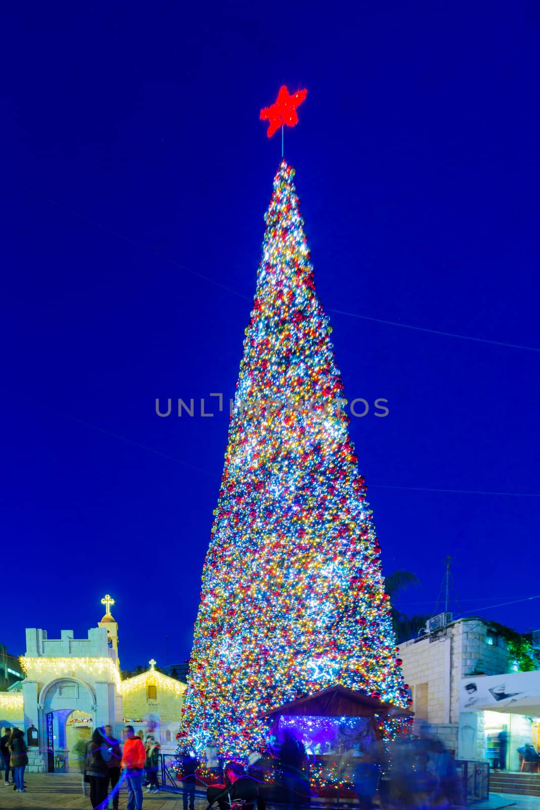 NAZARETH, ISRAEL - DECEMBER 20, 2016: Christmas scene of Mary Well square, with the Greek Orthodox Church of the Annunciation, a Christmas tree, locals and tourists, in Nazareth, Israel