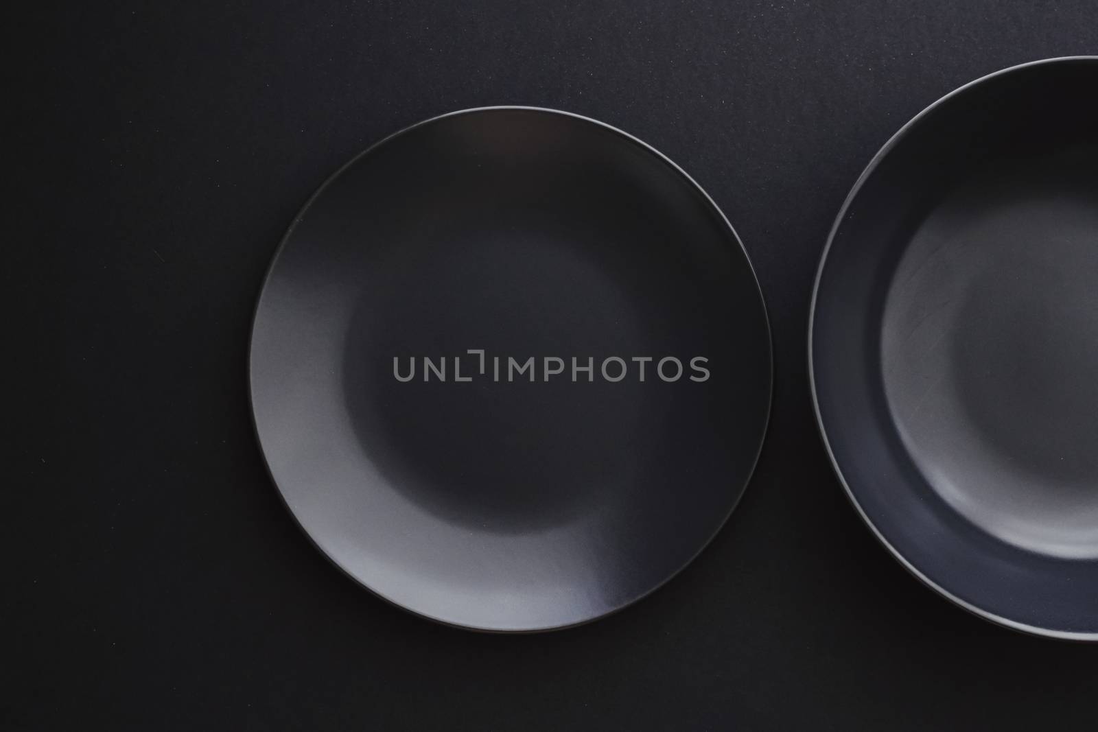 Empty plates on black background, premium dishware for holiday dinner, minimalistic design and diet by Anneleven