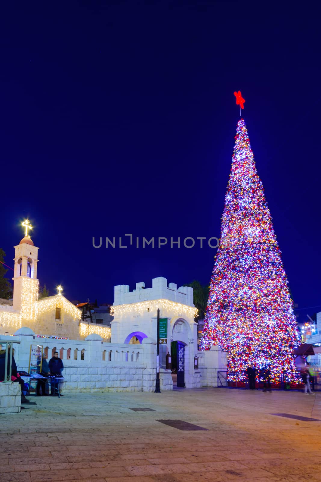 NAZARETH, ISRAEL - DECEMBER 20, 2016: Christmas scene of Mary Well square, with the Greek Orthodox Church of the Annunciation, a Christmas tree, locals and tourists, in Nazareth, Israel