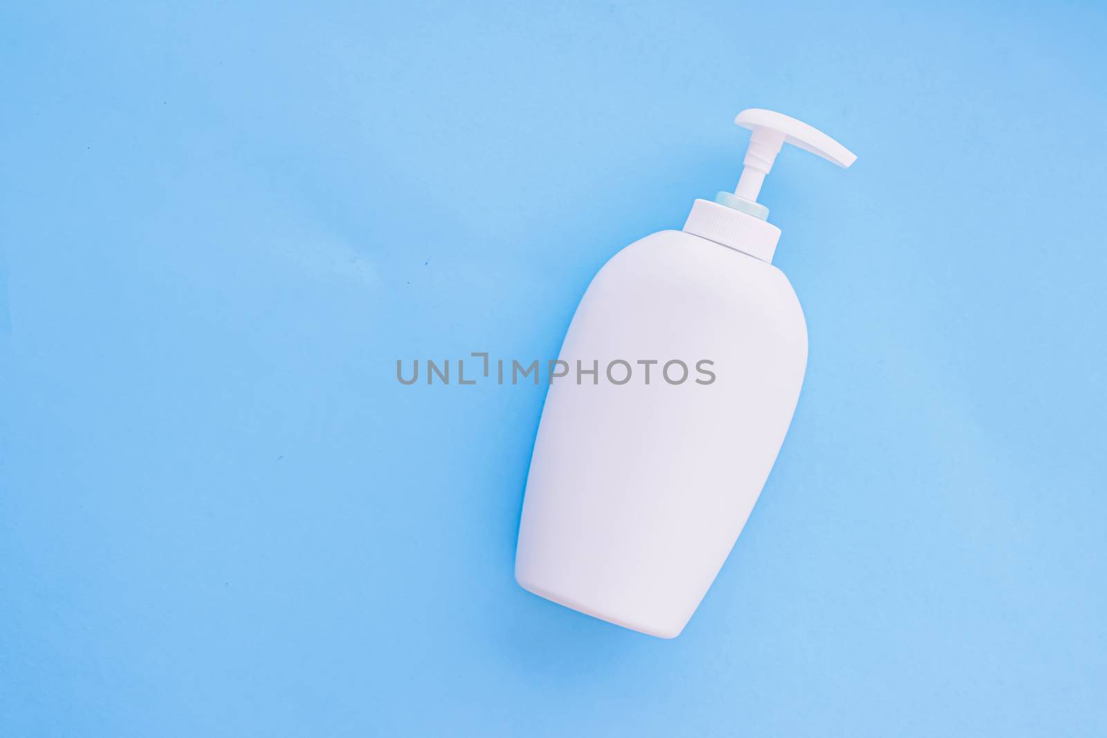 Blank label cosmetic container bottle as product mockup on blue background by Anneleven