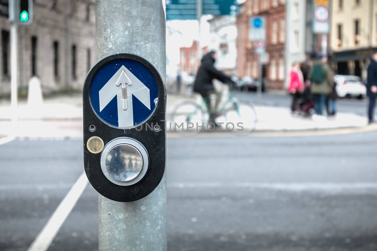 button to activate pedestrian crossing on the road on a pedestrian crossing in the city center on a winter day