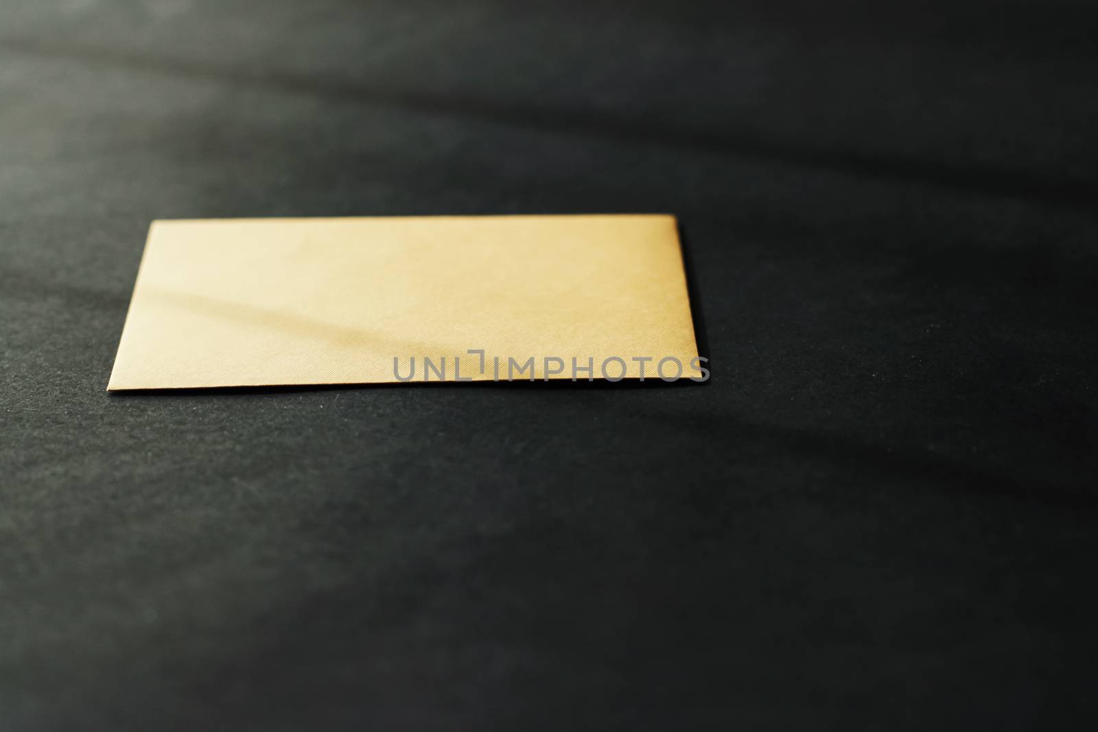 Blank golden paper card on black background, premium business and luxury brand identity mockup