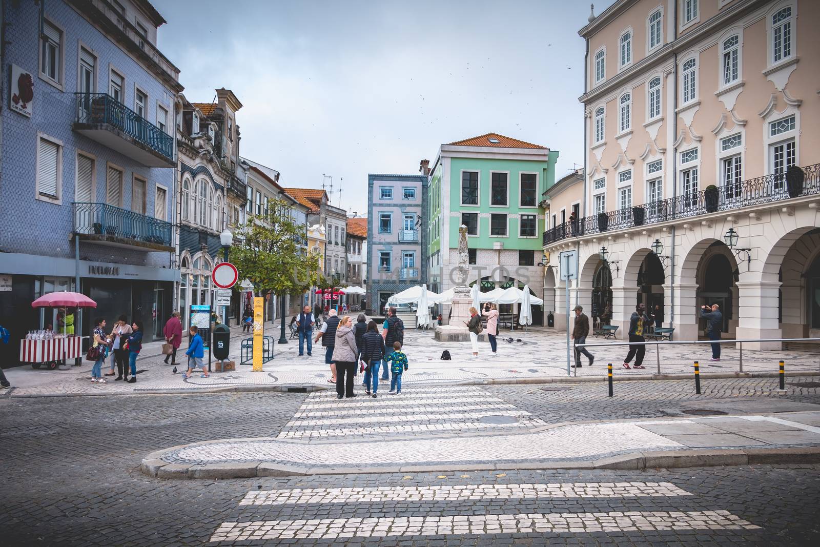 Aveiro, Portugal - May 7, 2018: People walking in a shopping street in the historic city center on a spring day