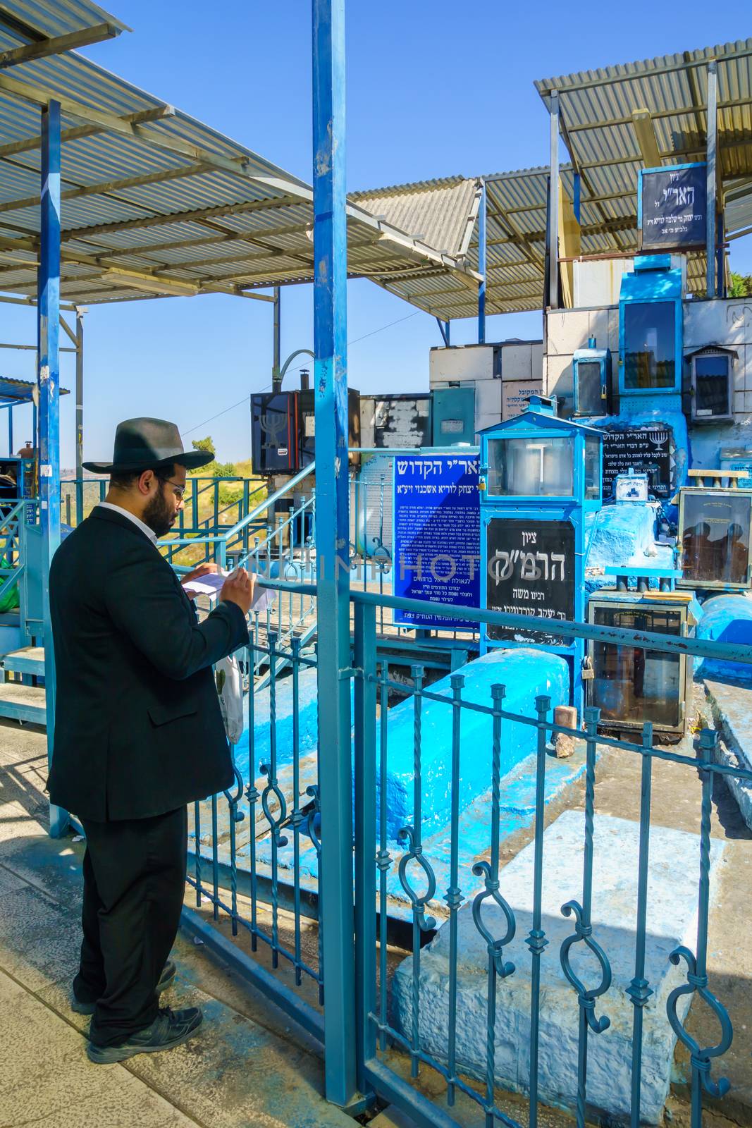 SAFED, ISRAEL - SEPTEMBER 18, 2015: Jewish man prays at the tomb of The ARI (Rabbi Isaac Luria), in Safed, Israel