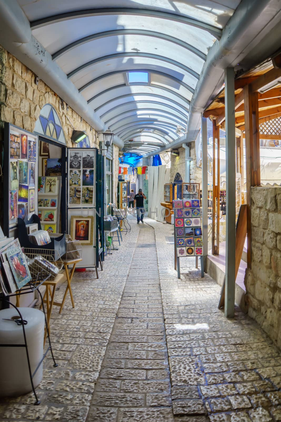 SAFED, ISRAEL - SEPTEMBER 18, 2015: An alley in the Jewish quarter, with local galleries and other businesses, locals and tourists, in Safed, Israel