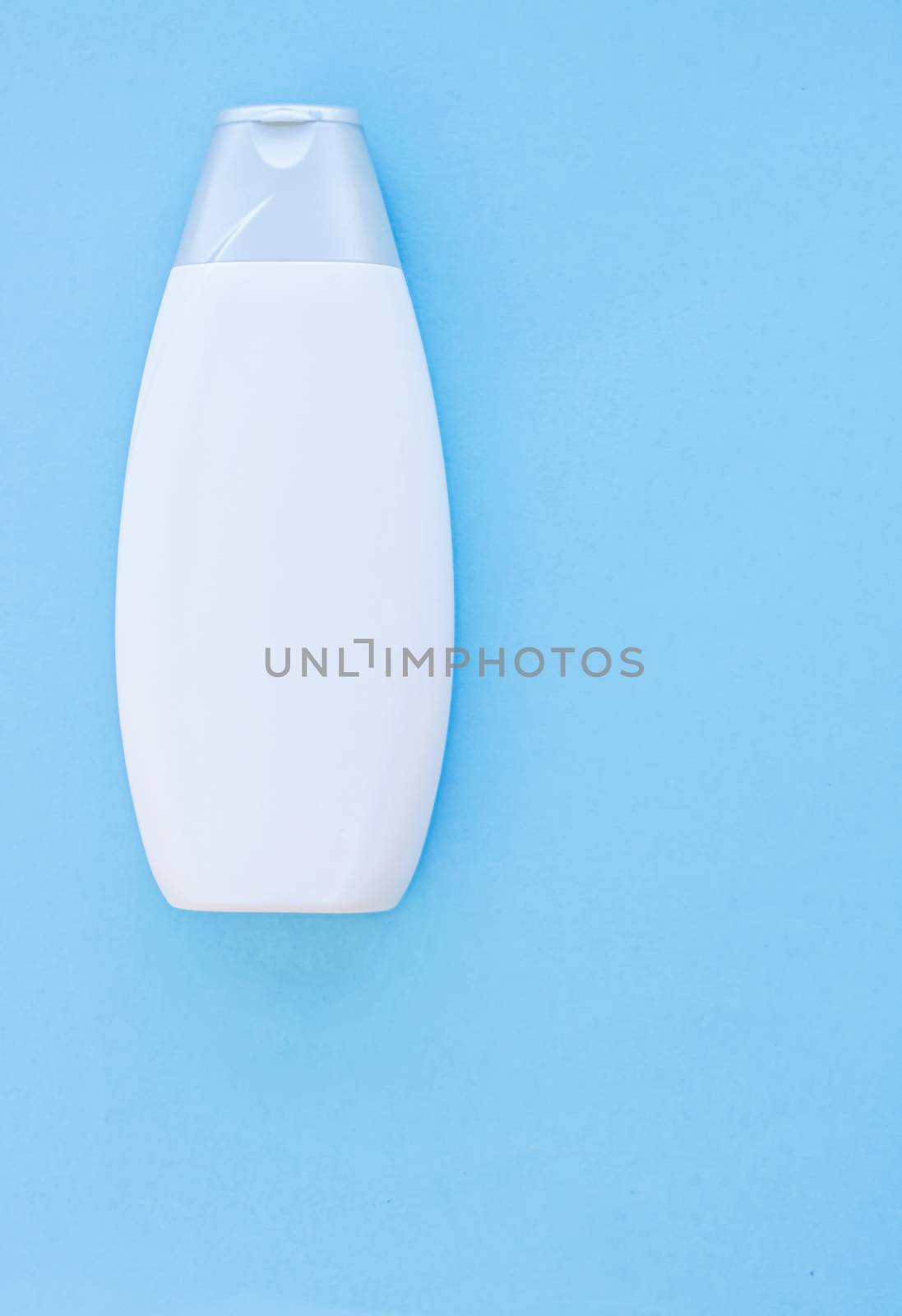 Blank label cosmetic container bottle as product mockup on blue background, hygiene and healthcare