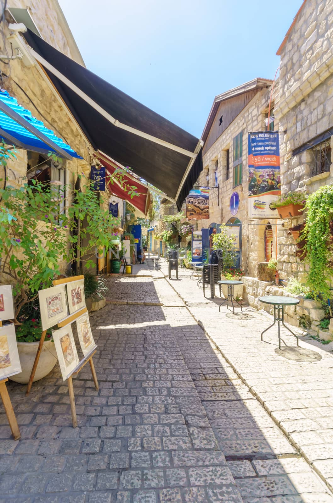 SAFED, ISRAEL - SEPTEMBER 18, 2015: An alley in the Jewish quarter, with local galleries and other businesses, locals and tourists, in Safed, Israel