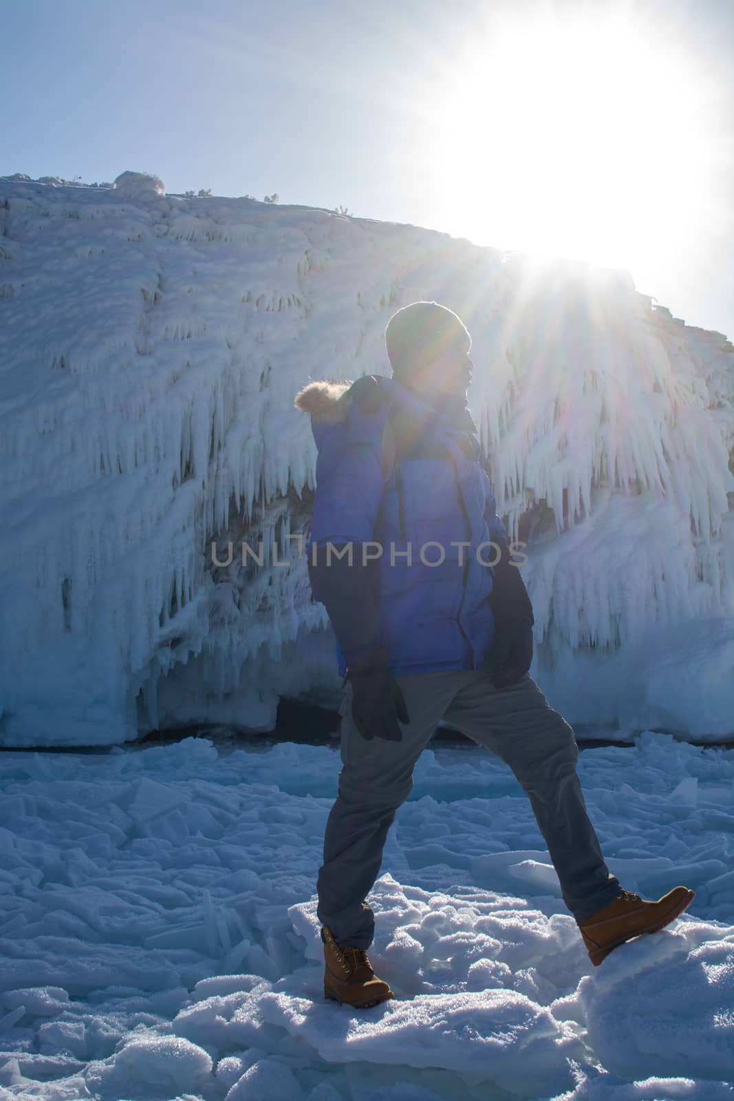 Man walking on  ice in frozen lake at Lake Baikal, Russia, A man doing solo outdoor activity, enjoying time alone in nature