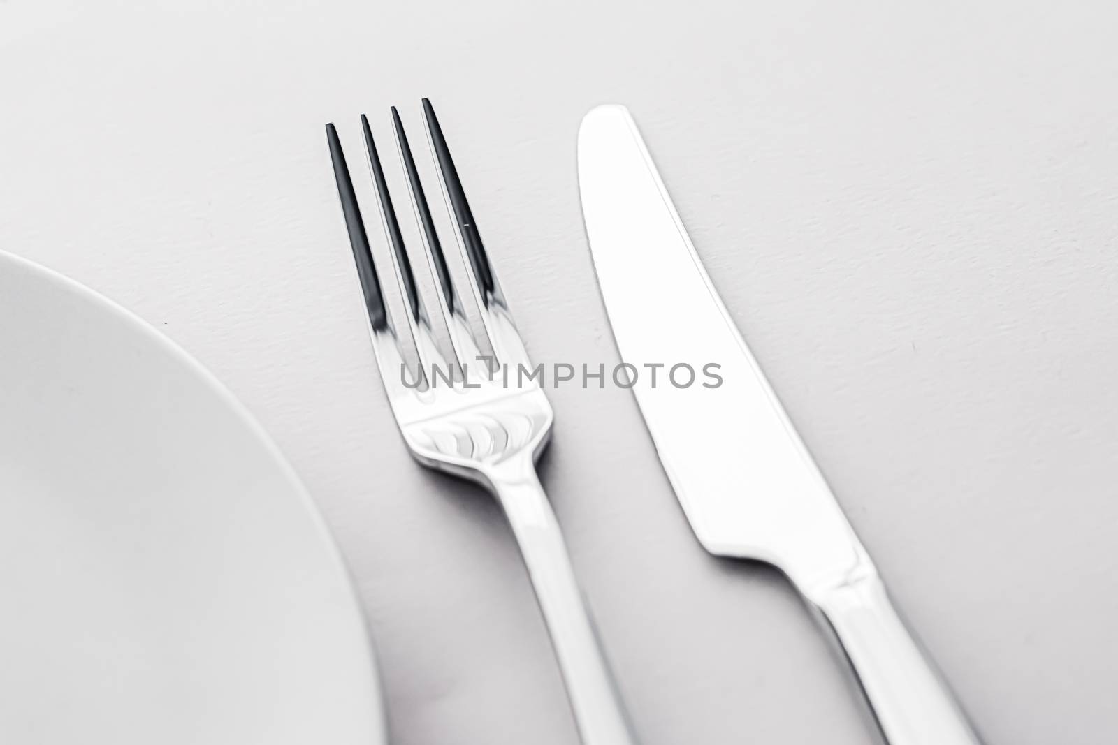 Empty plate and cutlery as mockup set on white background, top tableware for chef table decor and menu branding by Anneleven