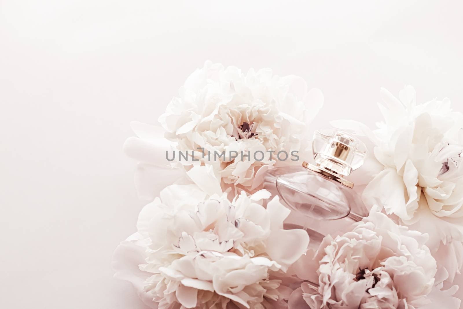 Fragrance bottle as luxury perfume product on background of peony flowers, parfum ad and beauty branding by Anneleven