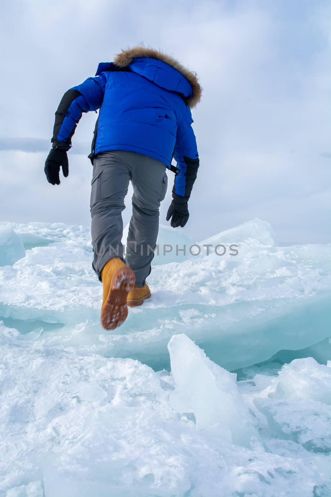 Man walking on  ice in frozen lake at Lake Bikal, Russia, A man doing solo outdoor activity, enjoying time alone in nature