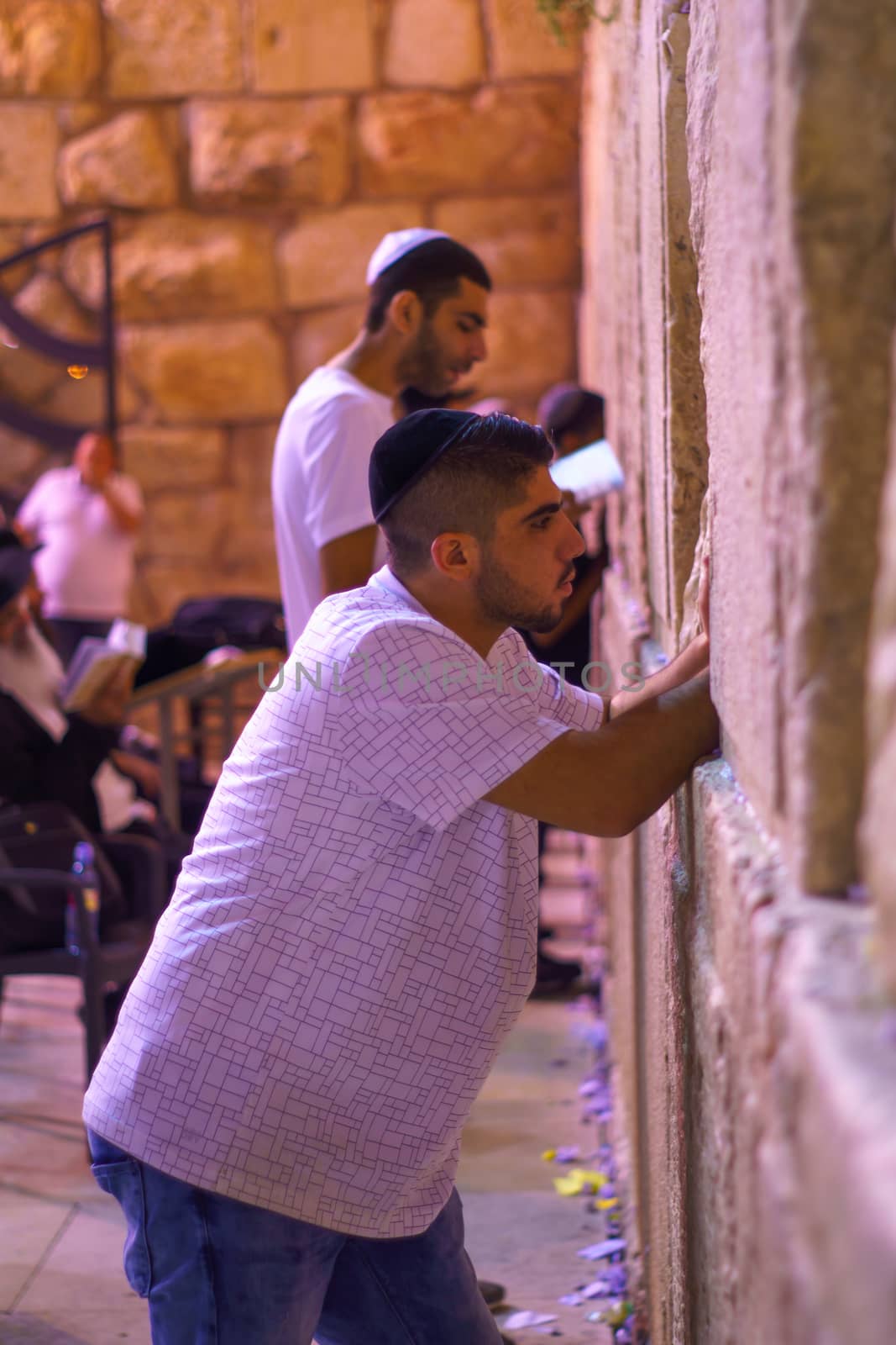 JERUSALEM, ISRAEL - SEPTEMBER 21, 2015: Jewish men pray Selichot (Jewish penitential prays) in the western wall, in the old city of Jerusalem, Israel