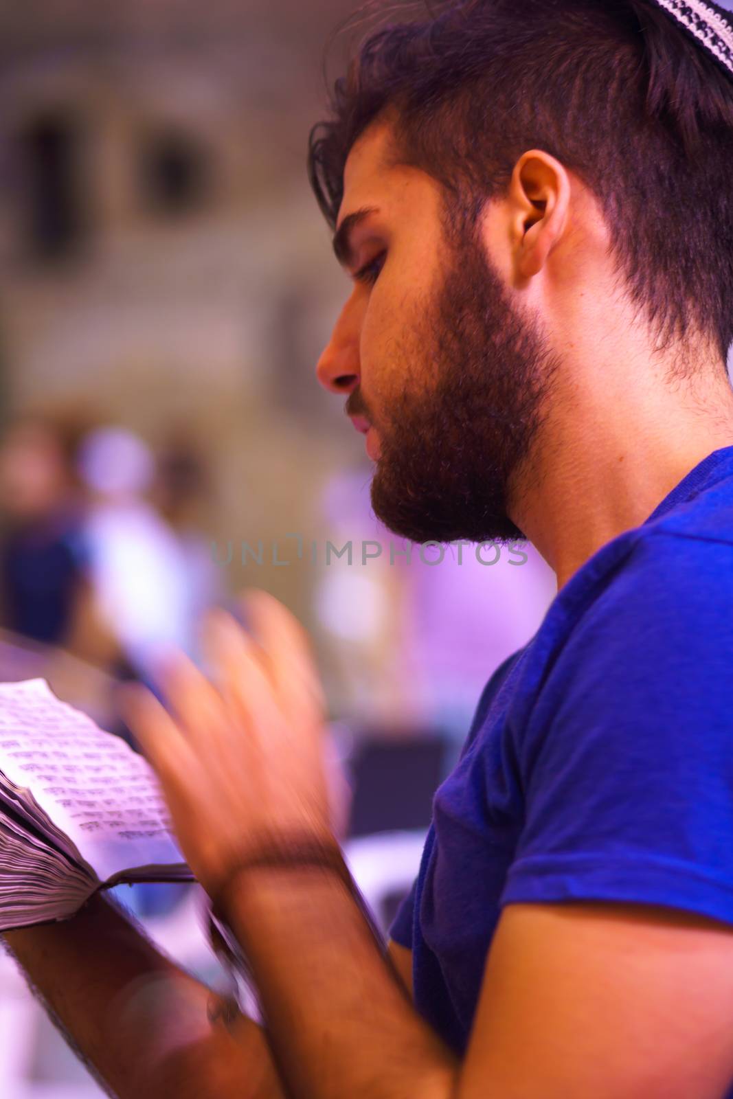 JERUSALEM, ISRAEL - SEPTEMBER 21, 2015: A Jewish man prays Selichot (Jewish penitential prays) in the western wall, in the old city of Jerusalem, Israel