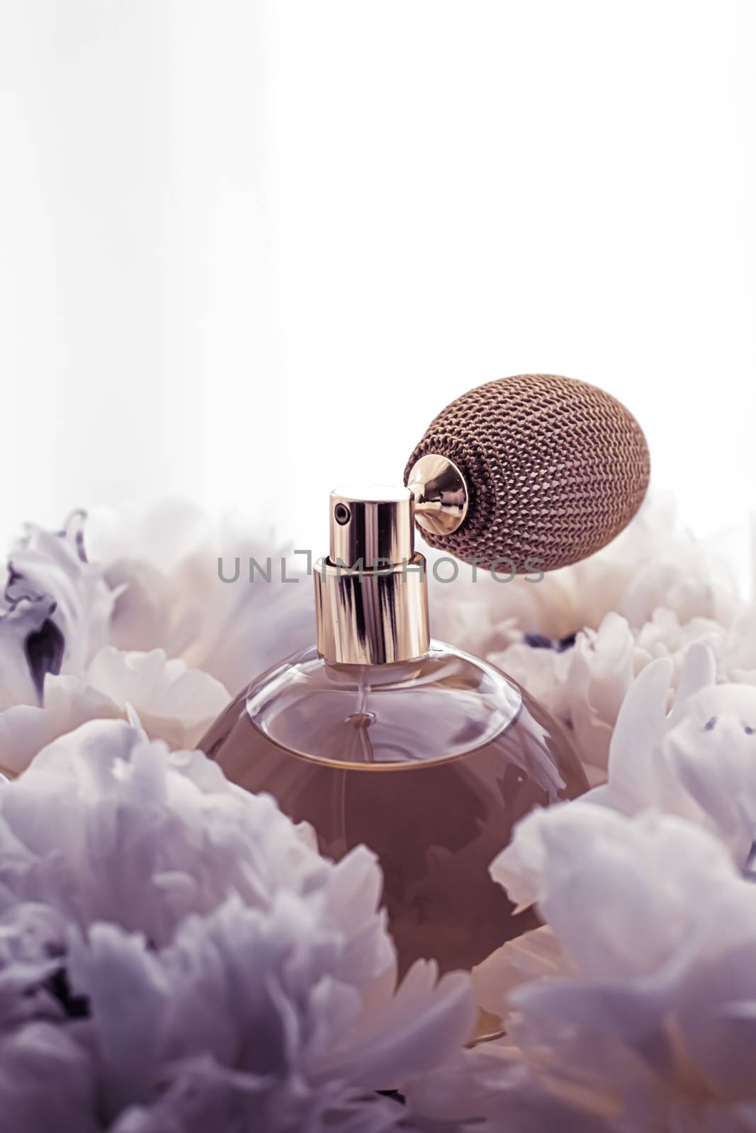 Luxe fragrance bottle as vintage perfume product on violet background and peony flowers, parfum ad and beauty branding design