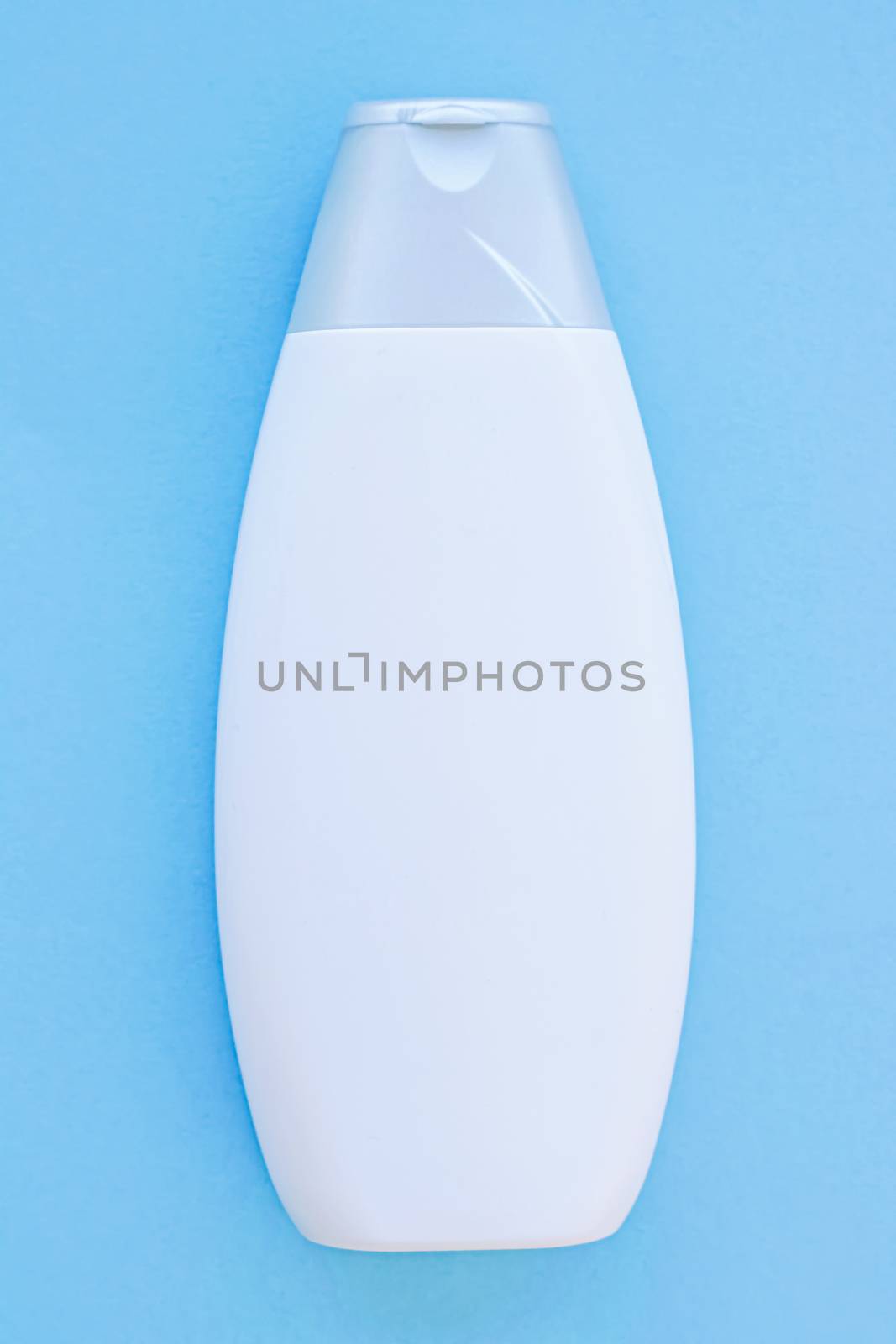 Blank label cosmetic container bottle as product mockup on blue background by Anneleven