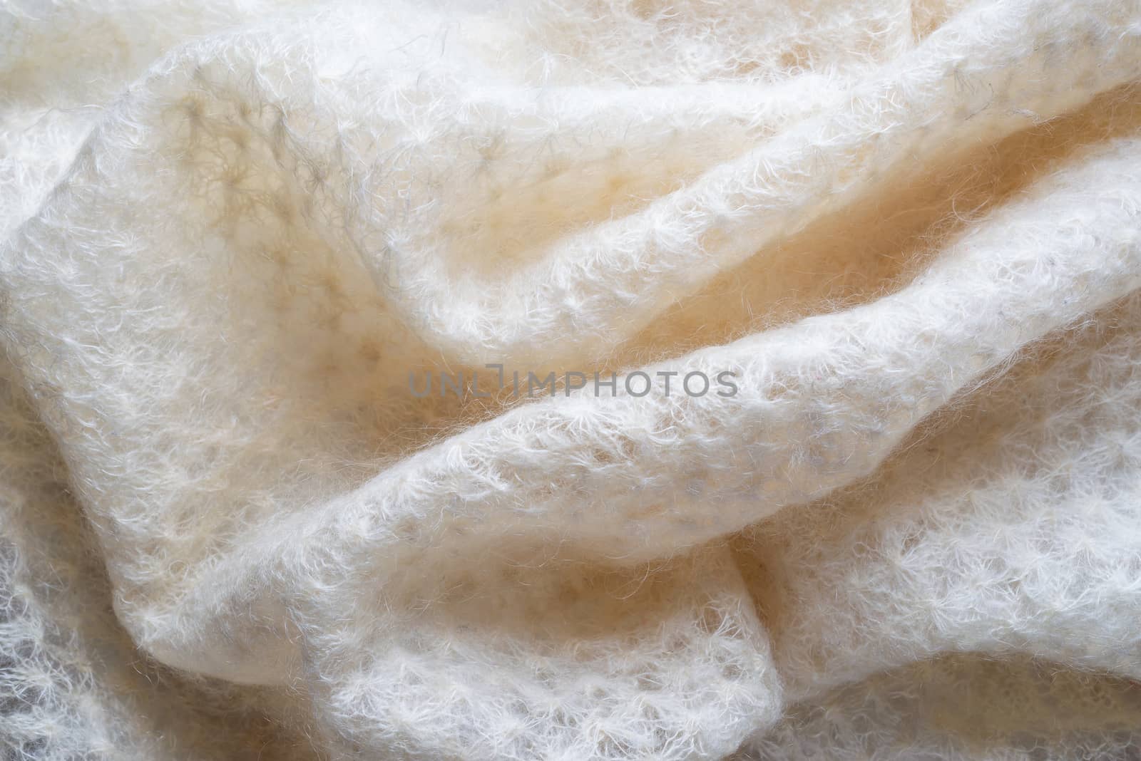 Soft folds of a white goat fluff scarf to be used as background