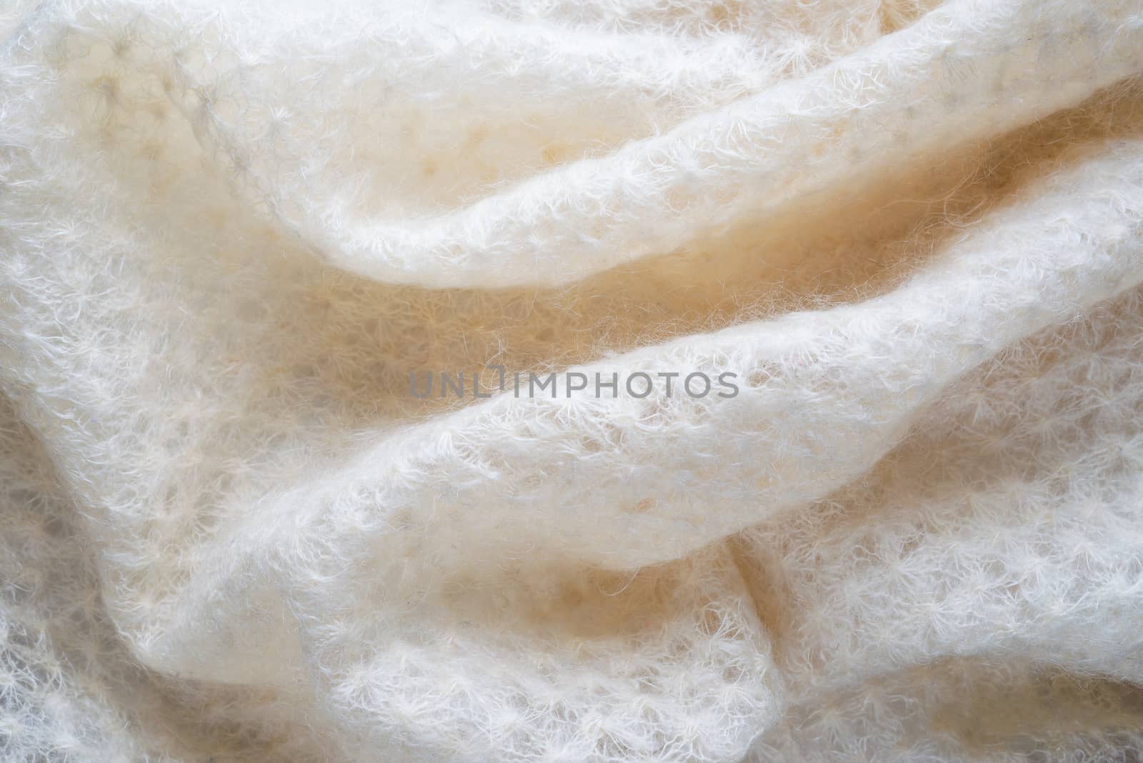 Soft folds of a white goat fluff scarf to be used as background