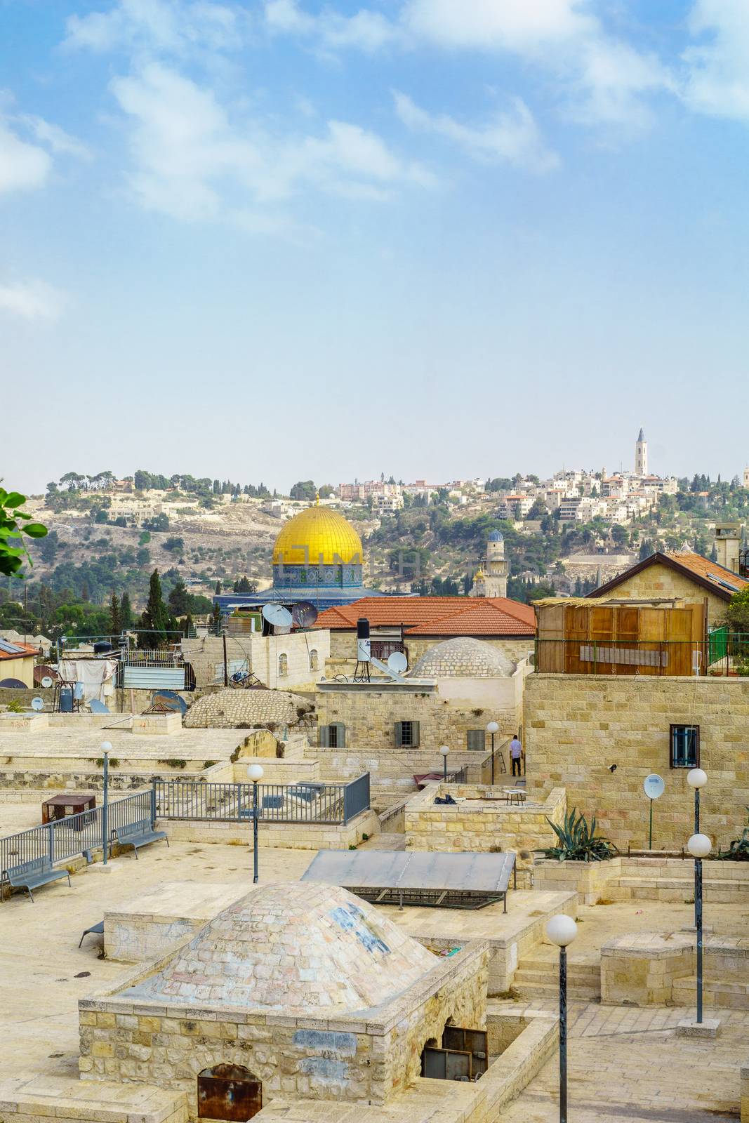 Jerusalem, Israel - October 19, 2018: Rooftop view, with the temple mount, other monuments, and a local, in the old city of Jerusalem, Israel