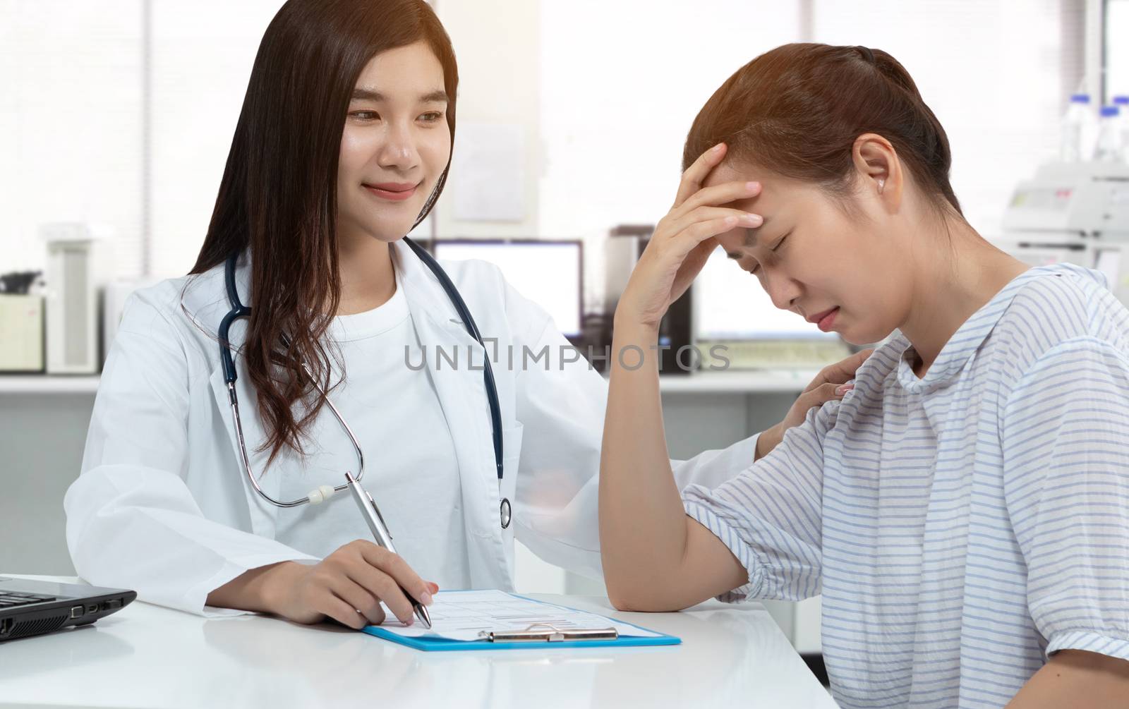 friendly Asian doctor with smiley face, touching stress patient on shoulder for soothe with gently calm in medical consultation room. supporting mental health, speech therapy, clients and psychologist by asiandelight