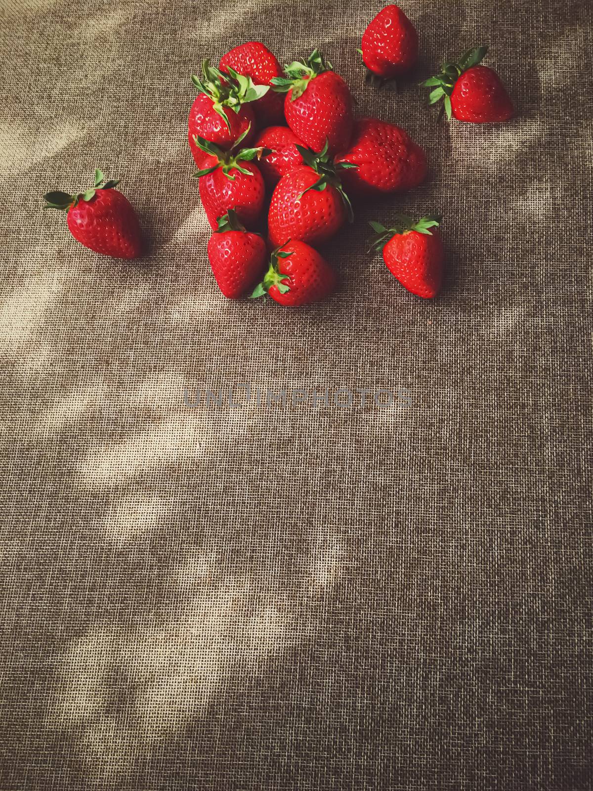 Organic strawberries on rustic linen background by Anneleven