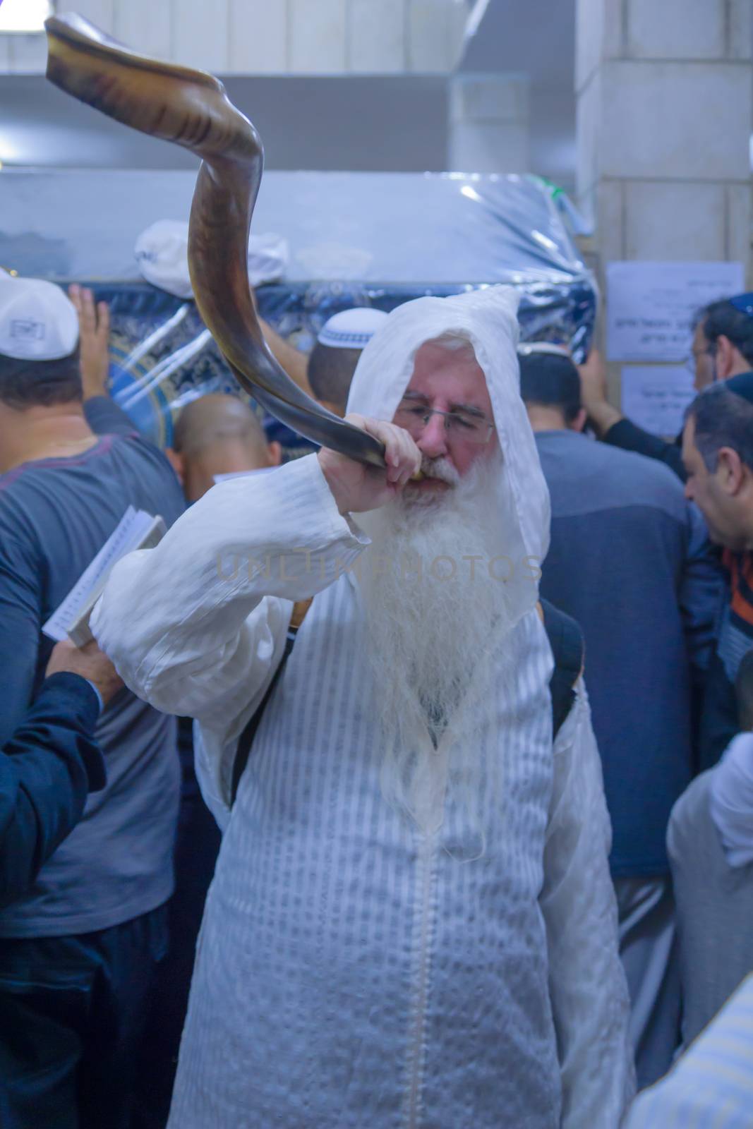 NETIVOT, ISRAEL - JANUARY 13, 2016: Jewish men blows a shofar at the Rabbi Israel Abuhaseira (Baba Sali) tomb, as part of the annual hillula of his memory. In Netivot, Israel