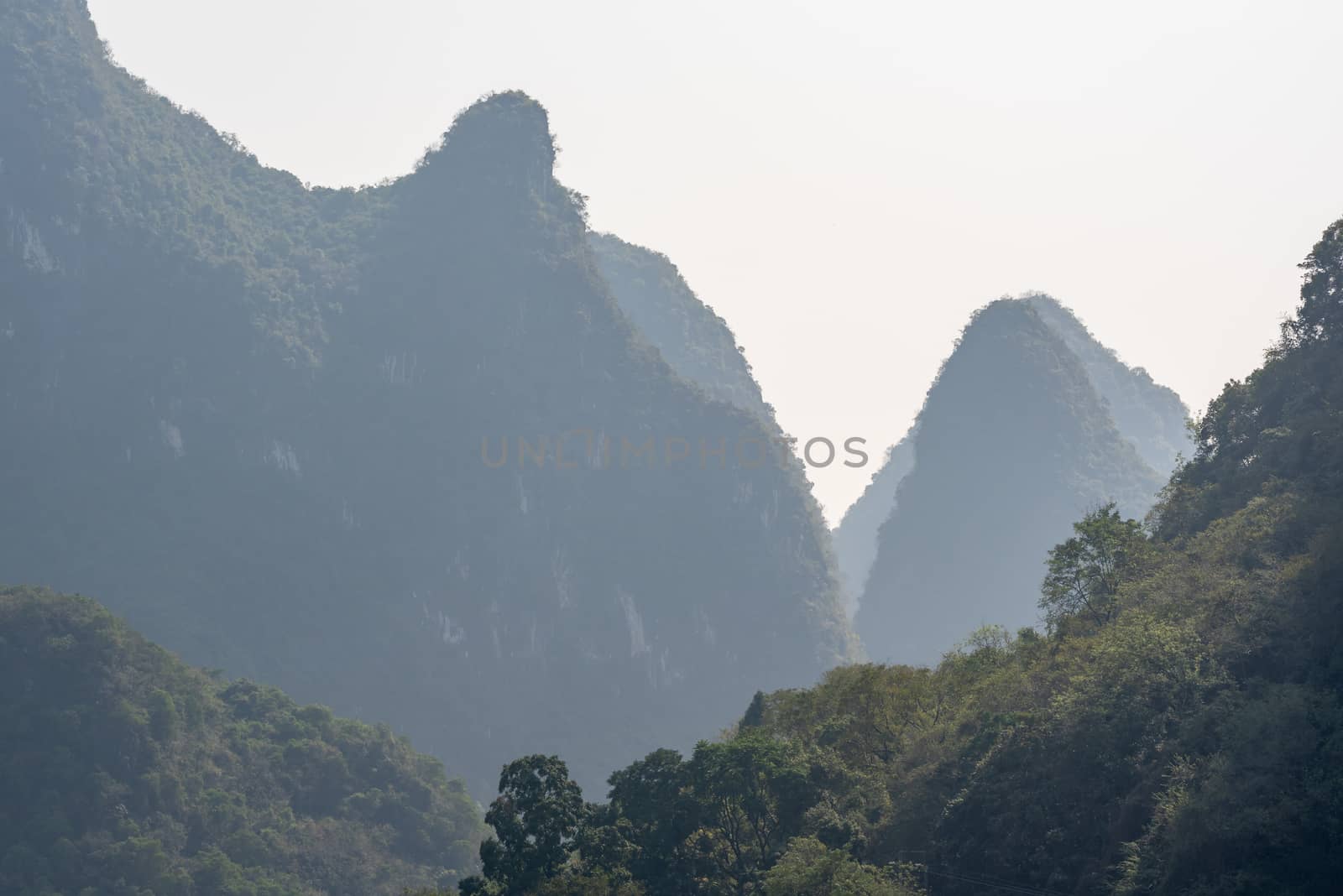 Karst formation and foggy limestone mountain landscape between Guiling and Yangshuo, Guangxi province, China